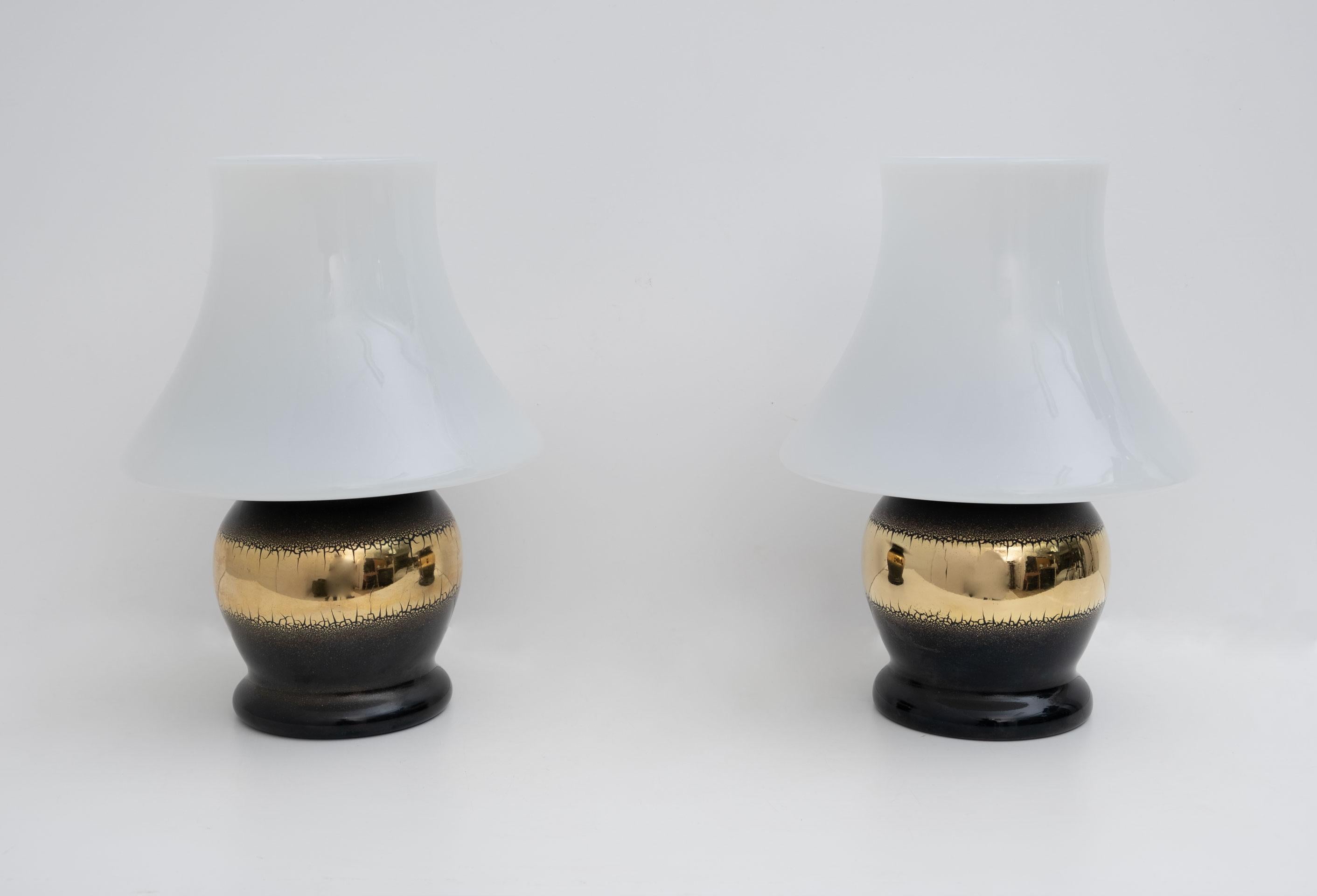 This pair of Murano glass mushroom lamps were produced by the Murano masters in the 1970s.
The lamps are made from a single blown glass and the black base is covered in 24 carat gold leaf.