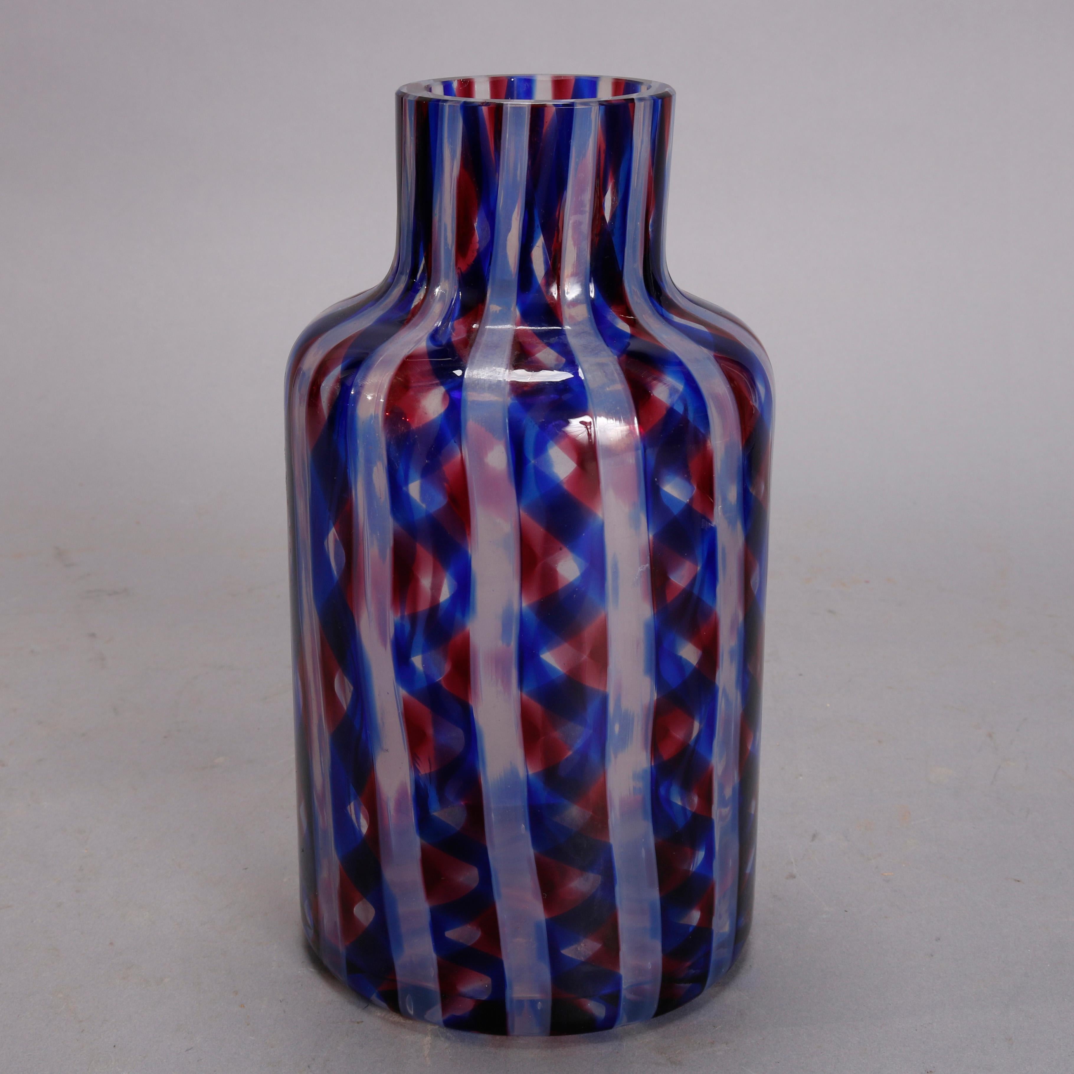 A Mid-Century Modern Italian Murano glass liquor decanter offers bottle form with swirled blue and red striping, 20th century

Measures: 11.5