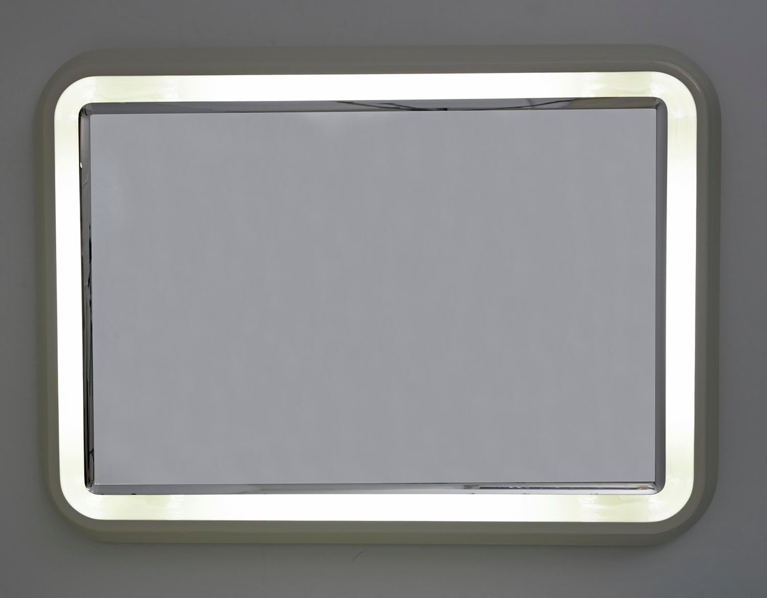 Simple but elegant rectangular mirror with rounded corners, original 1970s design and production. Neon backlight, working. White lacquered resin frame.
Overall it is in very good condition, there are small marks on the edge of the mirror.