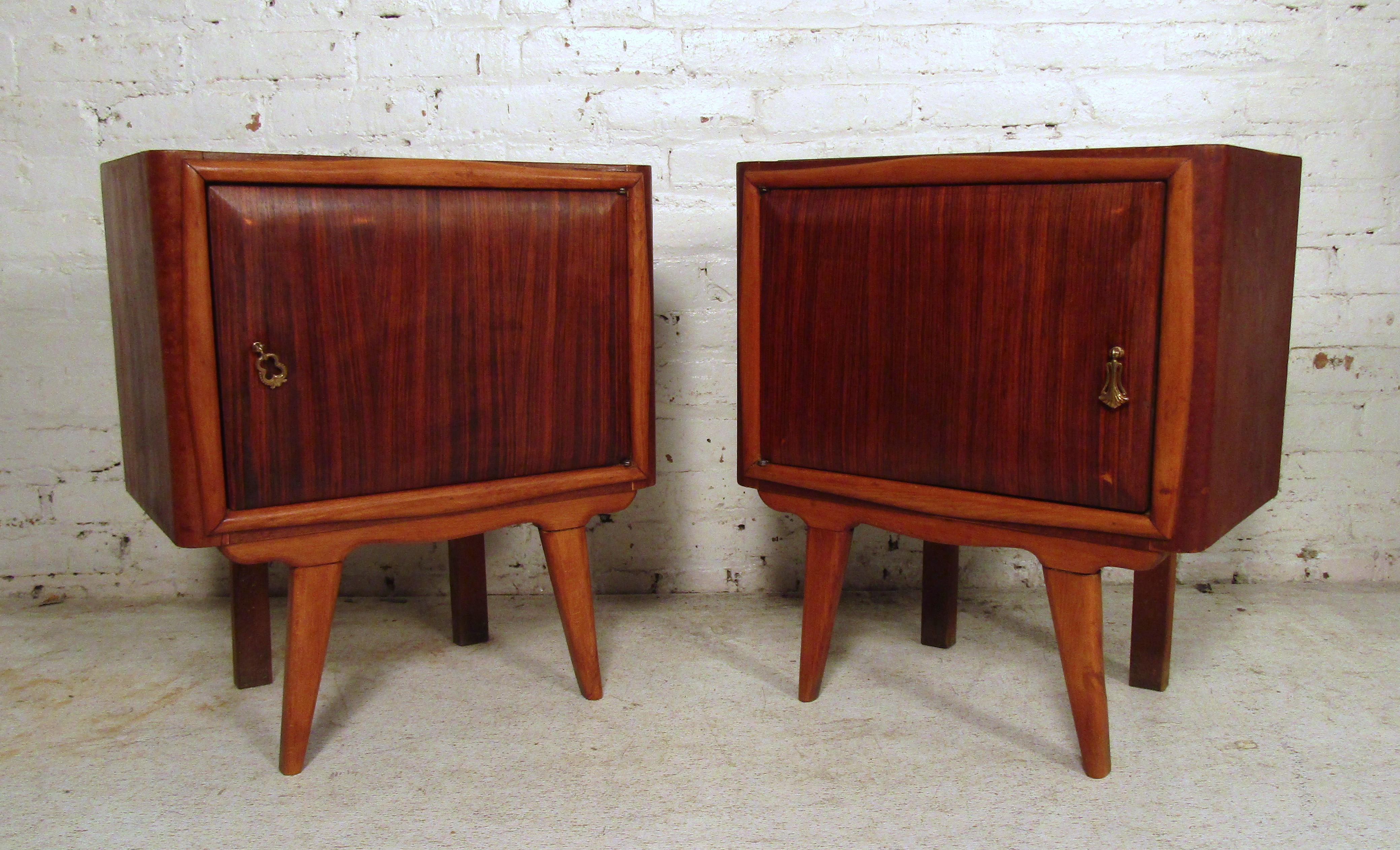 Sleek vintage modern side tables featured in rosewood and walnut. This pair of nightstands have a glass top, splayed legs, and a sturdy frame.

Please confirm item location (NY or NJ).