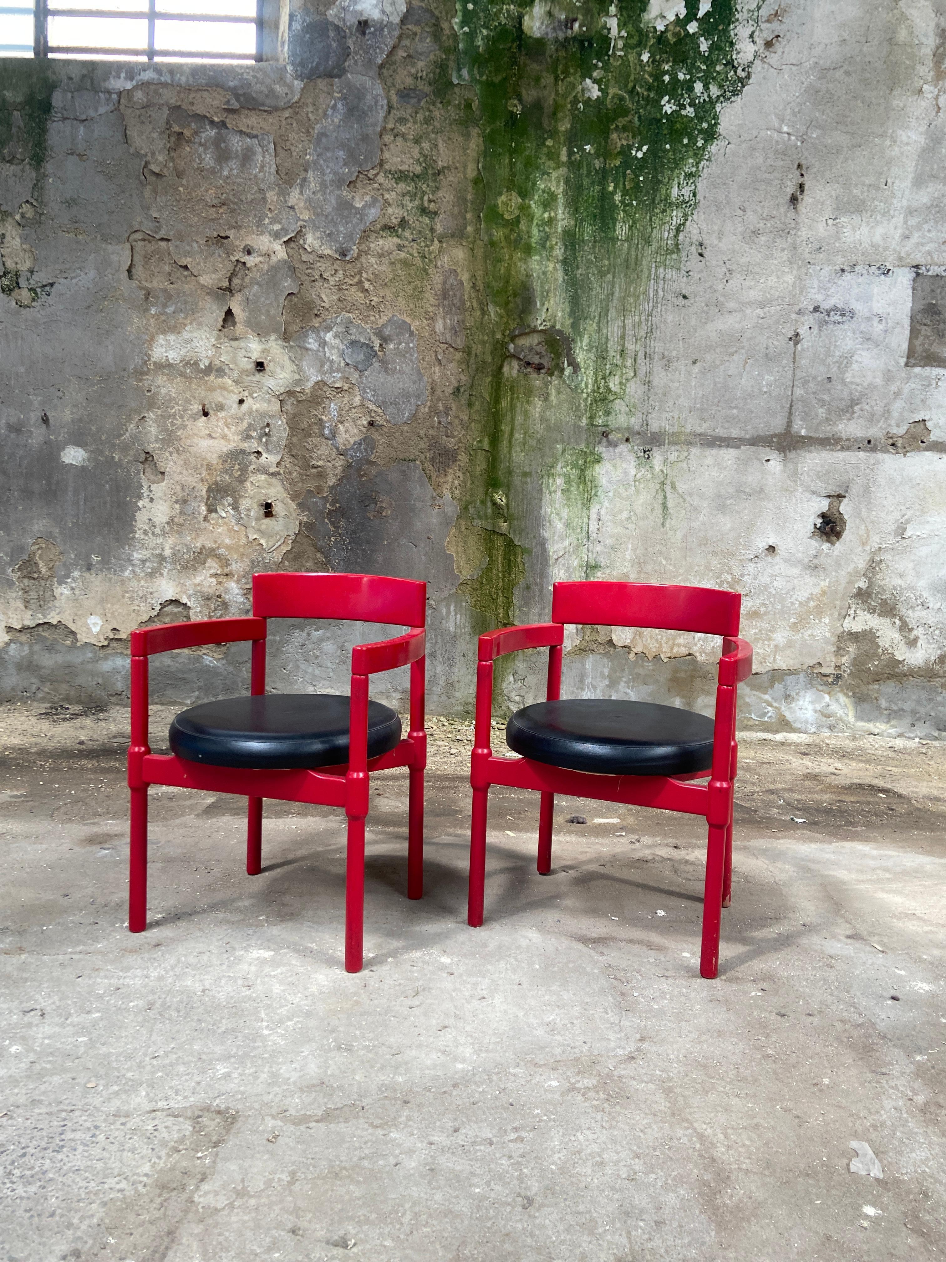 Mid-Century Modern Italian Pair of armchairs in lacquered wood with upholstered leather seat by Vico Magistretti. 1970s