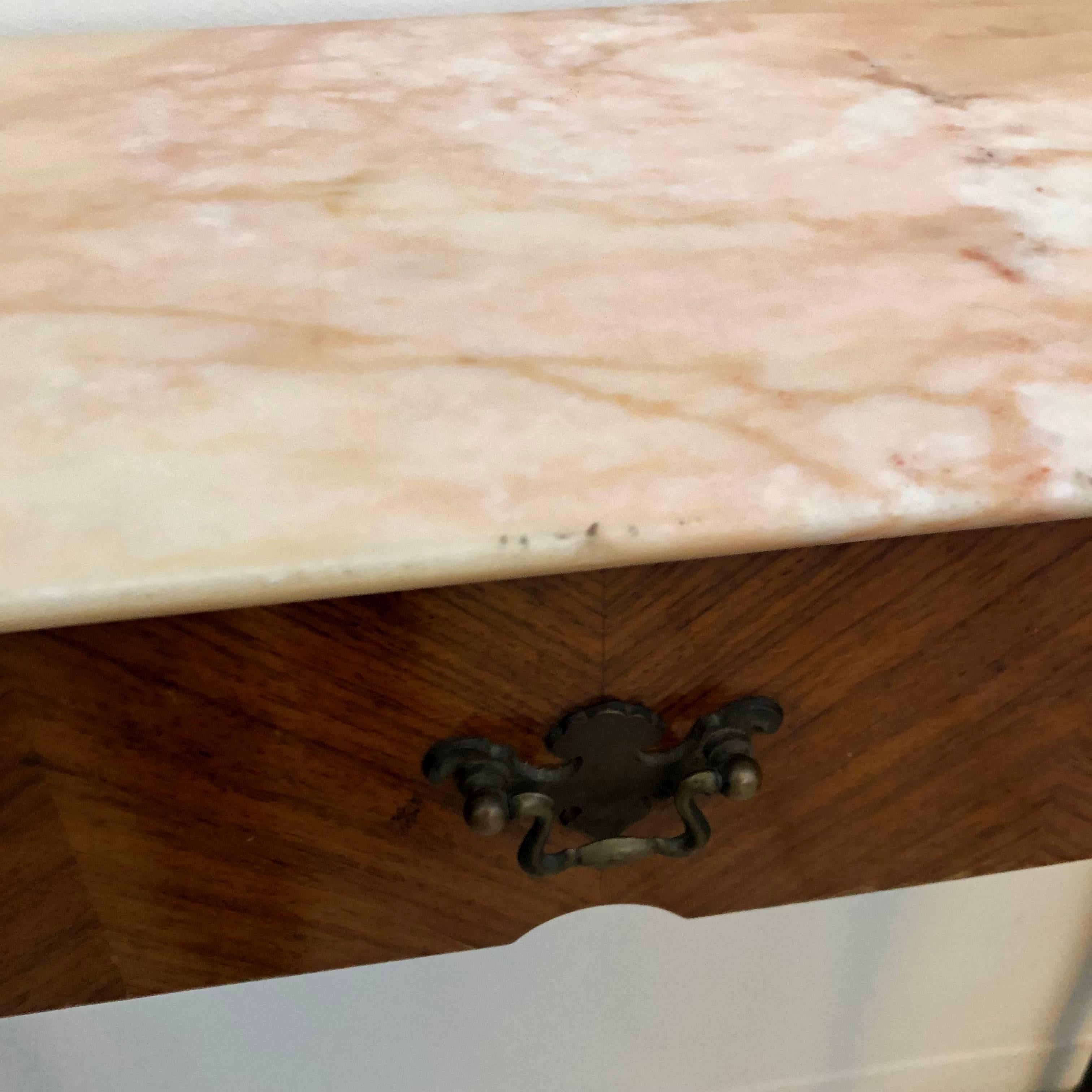 Nice console in the style of Paolo Buffa. It's veneered in rosewood, black painted foots and a pink Carrara marble on the top.
