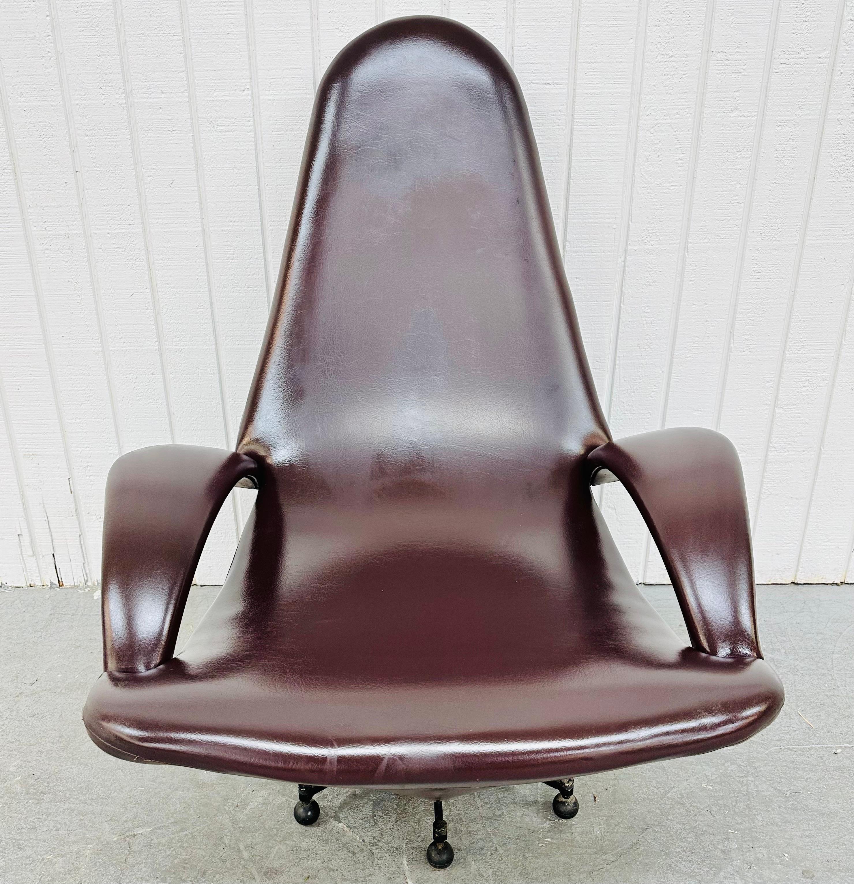 This listing is for a Mid-Century Modern Italian Lounge Chair. Featuring a low sitting design, high rounded back, curved arms, plum colored vinyl upholstery, and a black metal base. This is an exceptional combination of quality and design!