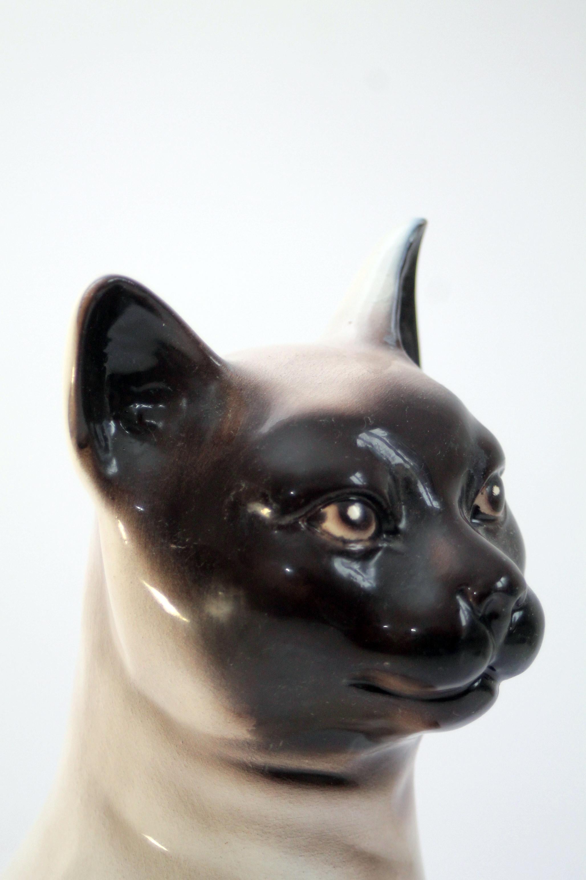 Hand made 1960's original modernist mid-century modern ceramic Siamese cat

Technique: colored glazed ceramics (barboutine)
Design period: early 1960's
Origin: Italy
Condition: Immaculate with no cracks, chips, or any visible flaw.

Dimensions: 