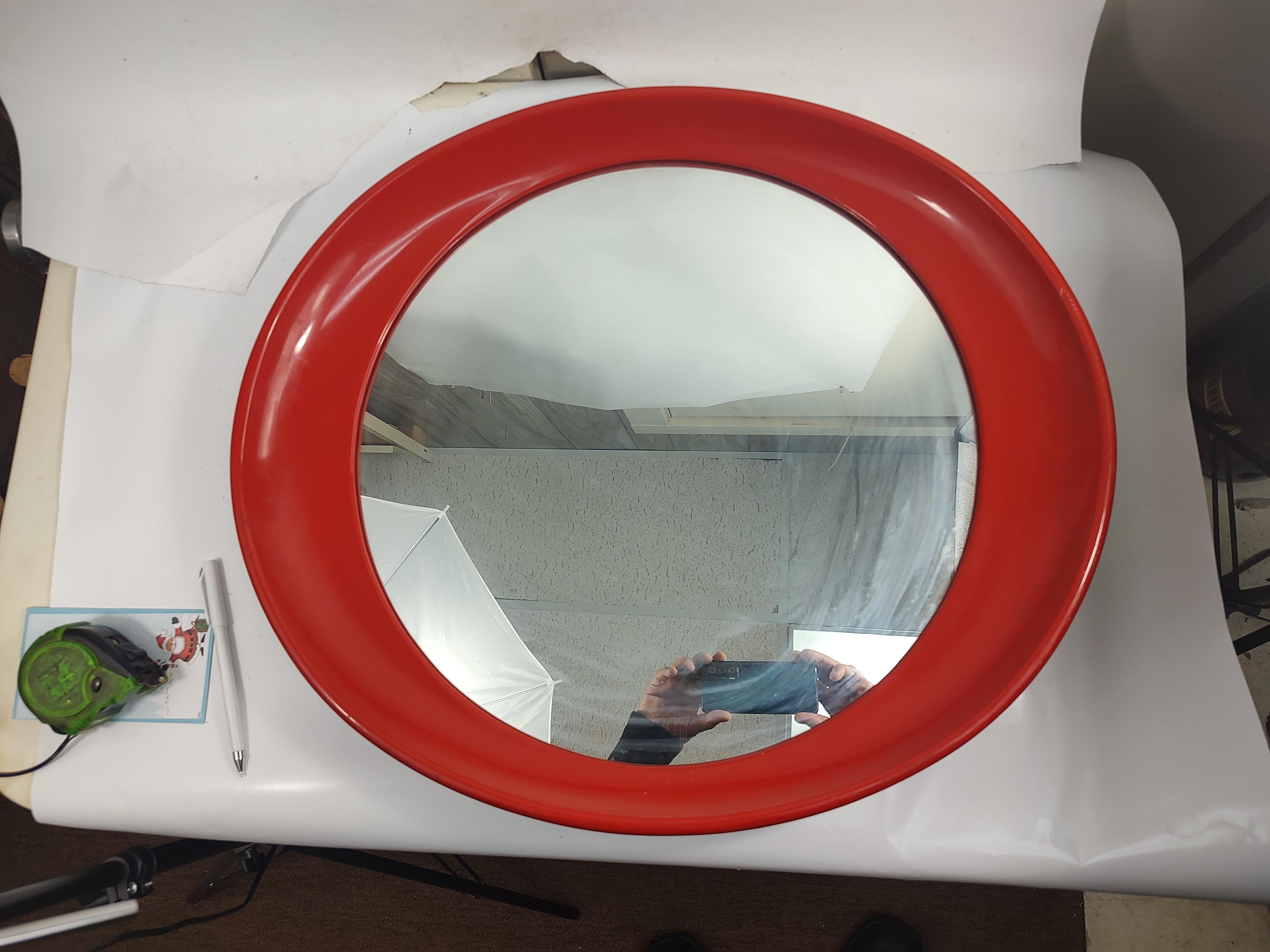 Fabulous Italian Red plastic oval mirror attributed to Joe Colombo c 1969. In excellent vintage condition with minimal wear. Mirror is excellent with no age related aging. 25.5 x 22 x 2.5d