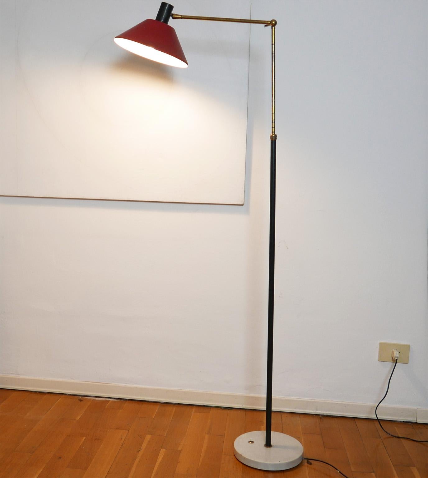Adjustable floor lamp edited by Stilux in 1950s
 Thanks to the brass arm and the little handle it s possible to change the arm position.
The red reflector is adjustable too.
The brass switch is on the white marble base.