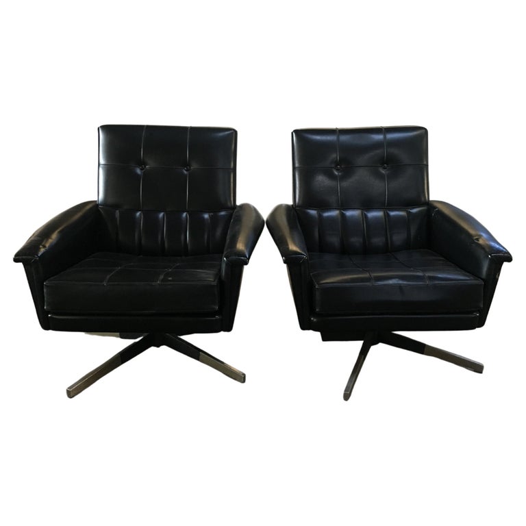 Mid-Century Modern pair of Italian revolving office armchairs in black faux leather with stainless steel legs, 1960s. 
The armchairs show some wear due to age and use. They are in general good vintage condition.
Cost for the restoration and fabric