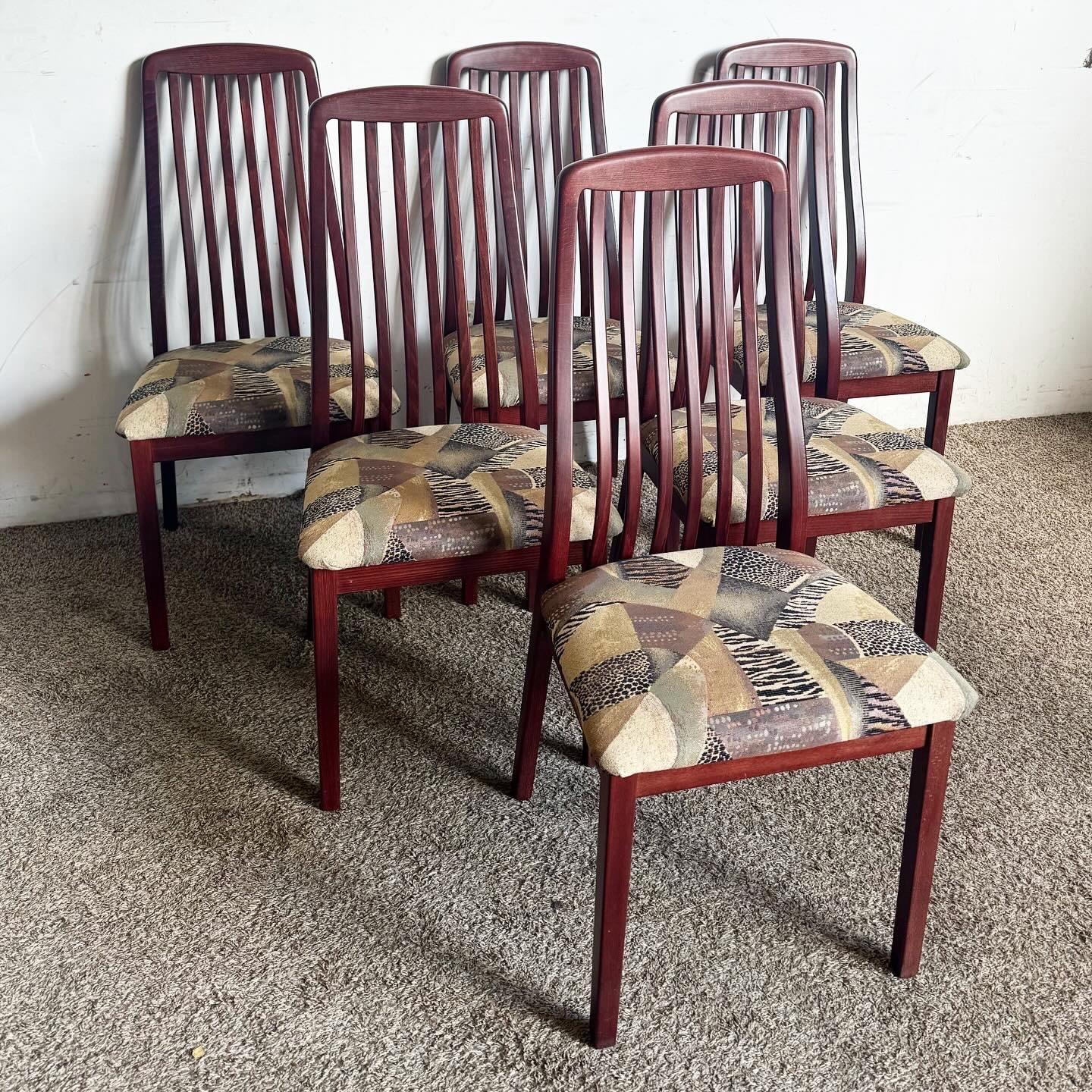 Experience timeless elegance with this set of 6 Mid Century Modern Italian Rosewood Dining Chairs by A. Sibau. These chairs boast sleek rosewood construction and bent backrests for enhanced comfort, combining luxurious design with optimal