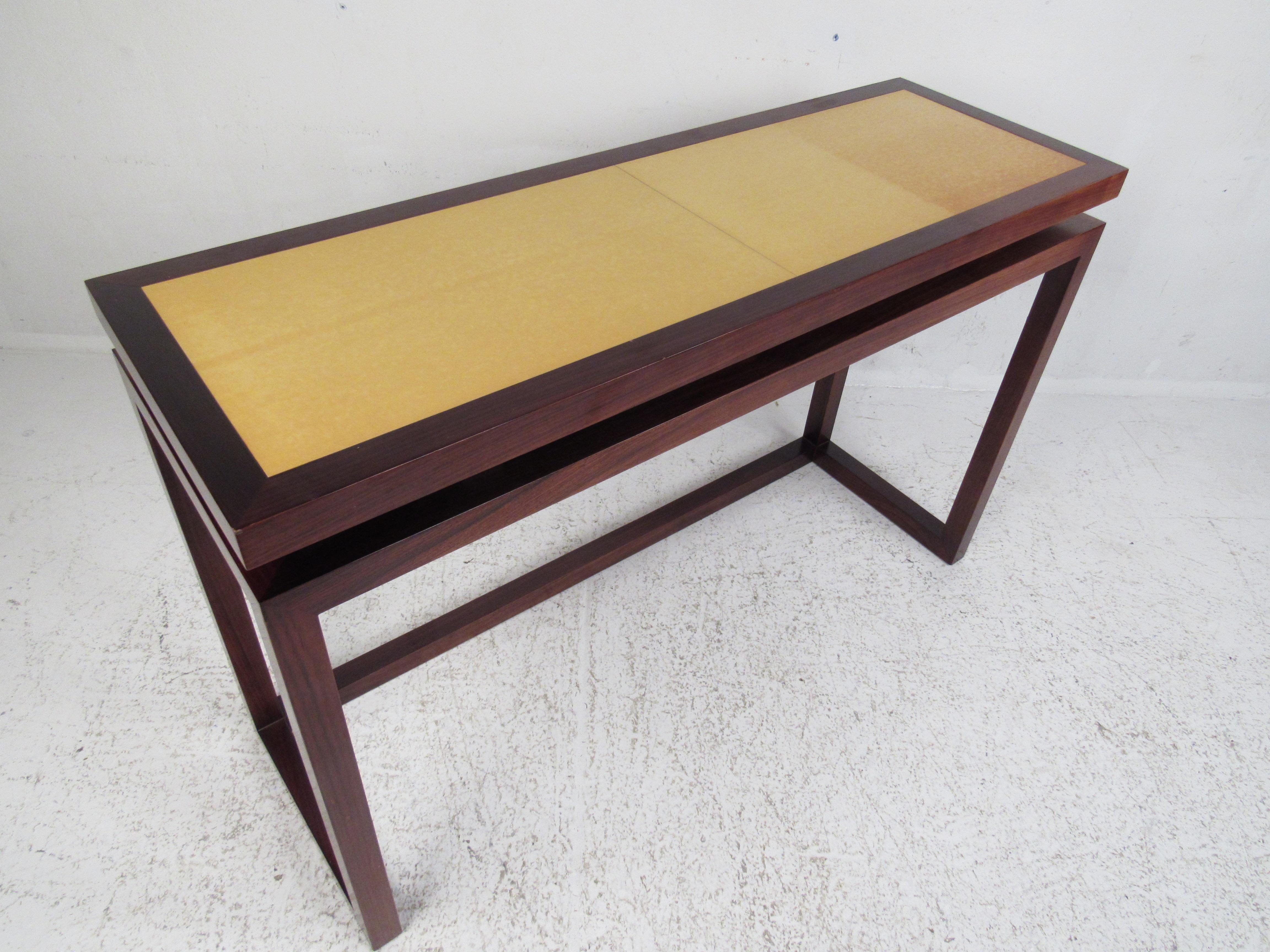 A stunning vintage modern sofa table with a raised top and a rosewood frame. The Italian two-tone design looks great in any entryway, hallway, or even behind the sofa. A sleek console table for the home, business, or office. Please confirm item