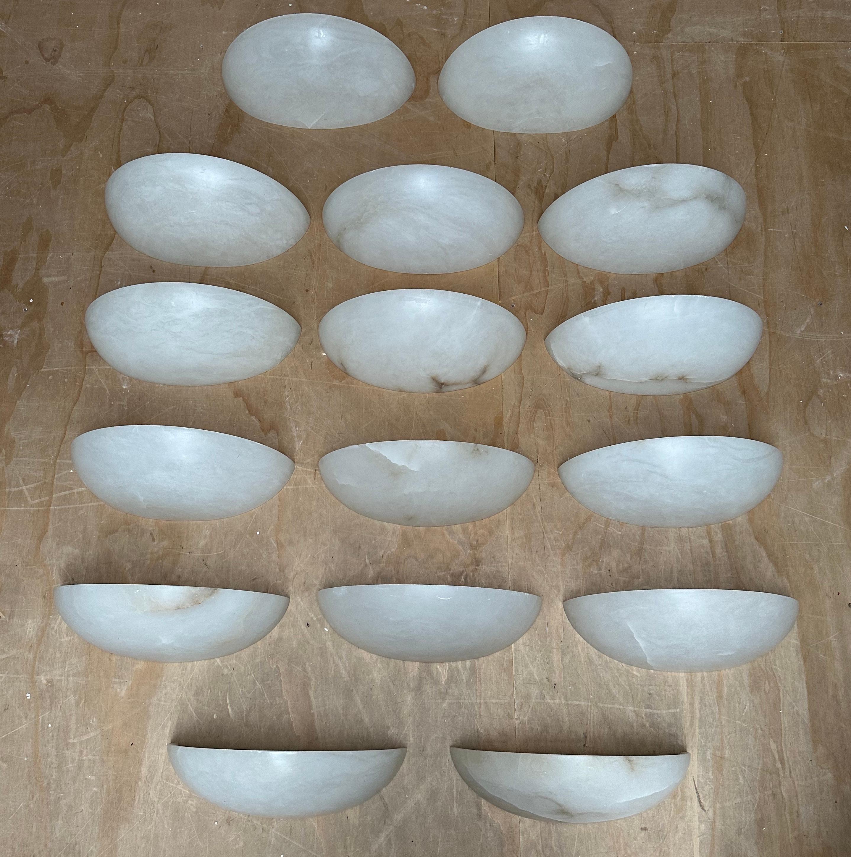 Great looking, half moon shape / design, easy to mount and beautifully handcrafted and extra large set of sixteen alabaster mineral stone wall lights.

In all our years of buying and selling (early) 20th century lighting we had never before seen a