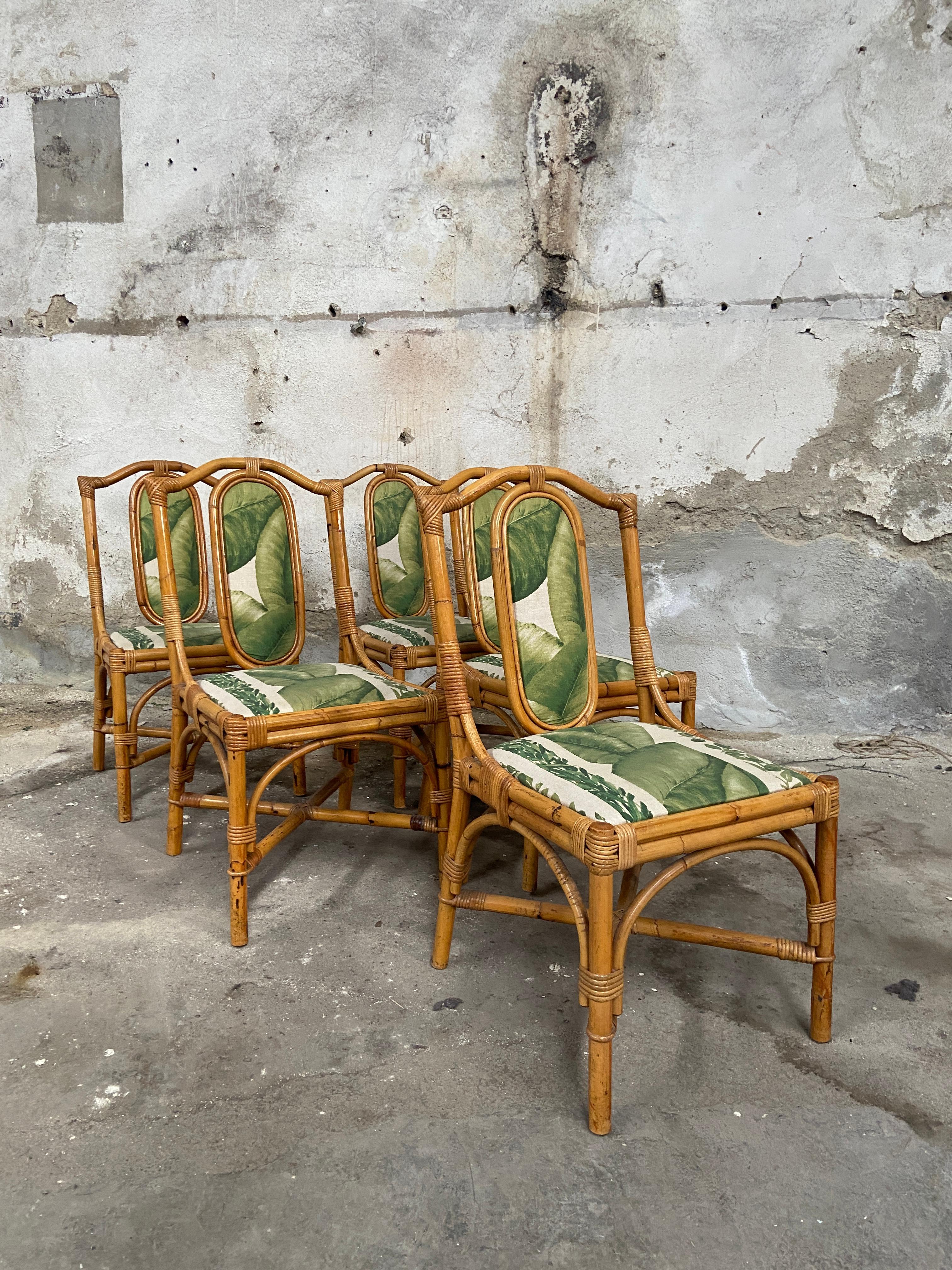 Mid-Century Modern Italian set of 5 bamboo and rattan dining chairs with original fabric. The set can come a set of 6 pieces due to an extra chair that does not have the back fabric panel. The cost for the set of 6 remain the same as for the one of
