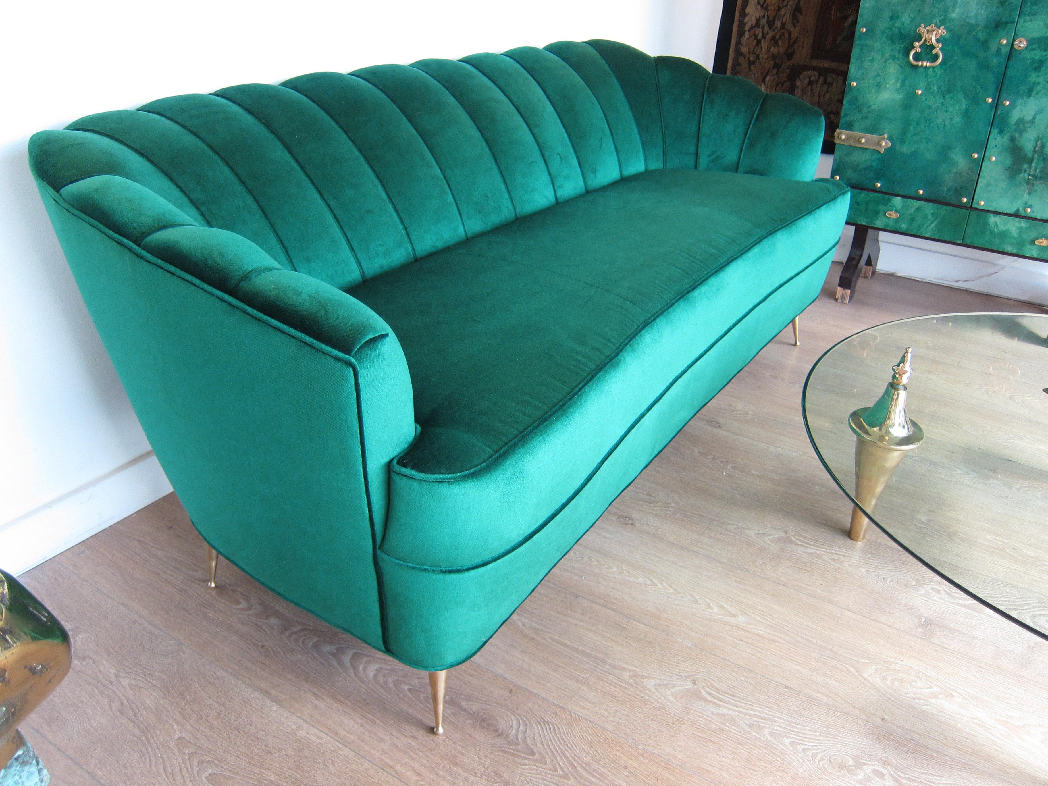 Italian Mid-Century Modern settee with scalloped back and brass legs. 
Newly upholstered with emerald green velvet, 
Attributed to Ico Parisi.
Located in our store in Miami ready for shipping.