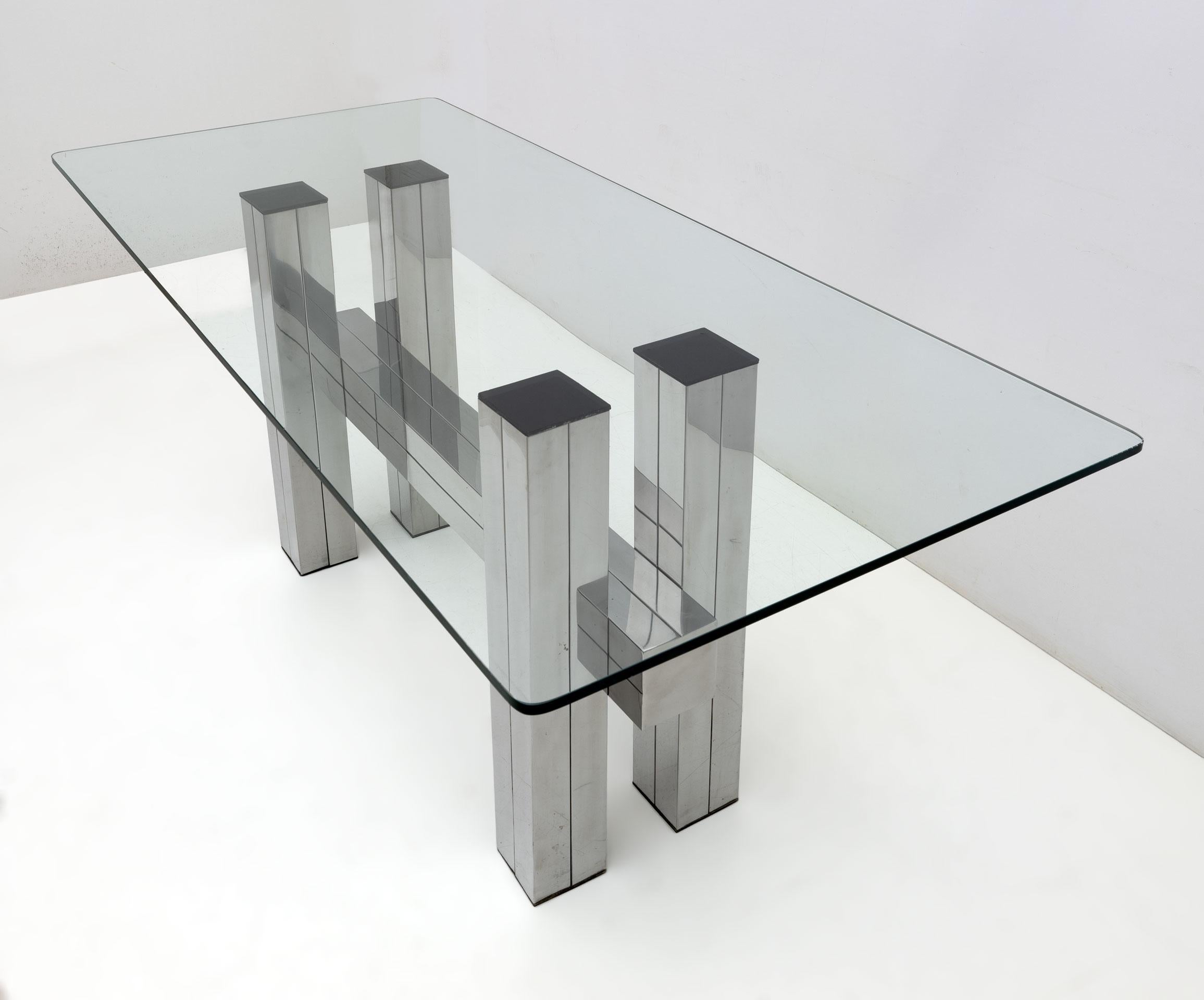 Italian postmodern style dining table, made in the 1980s in sheet steel and thick glass top.
Small signs of wear