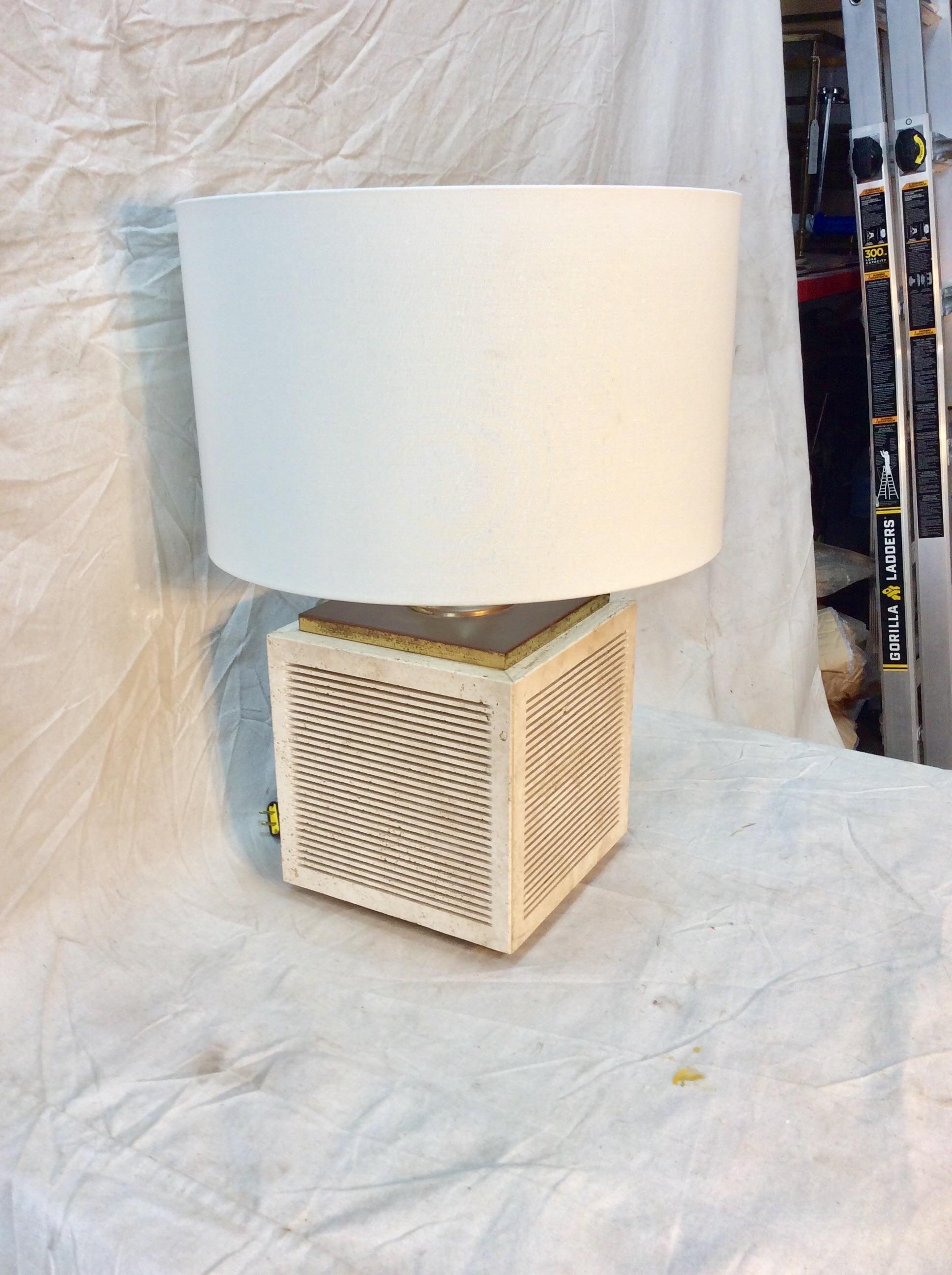 This highly collectable Mid-Century Modern Italian Table Lamp features a travertine cubic base and brass structure. The lamp is constructed with a three way switch to illuminate the base, the lamp and both the base and lamp. Attributed to Fratellli