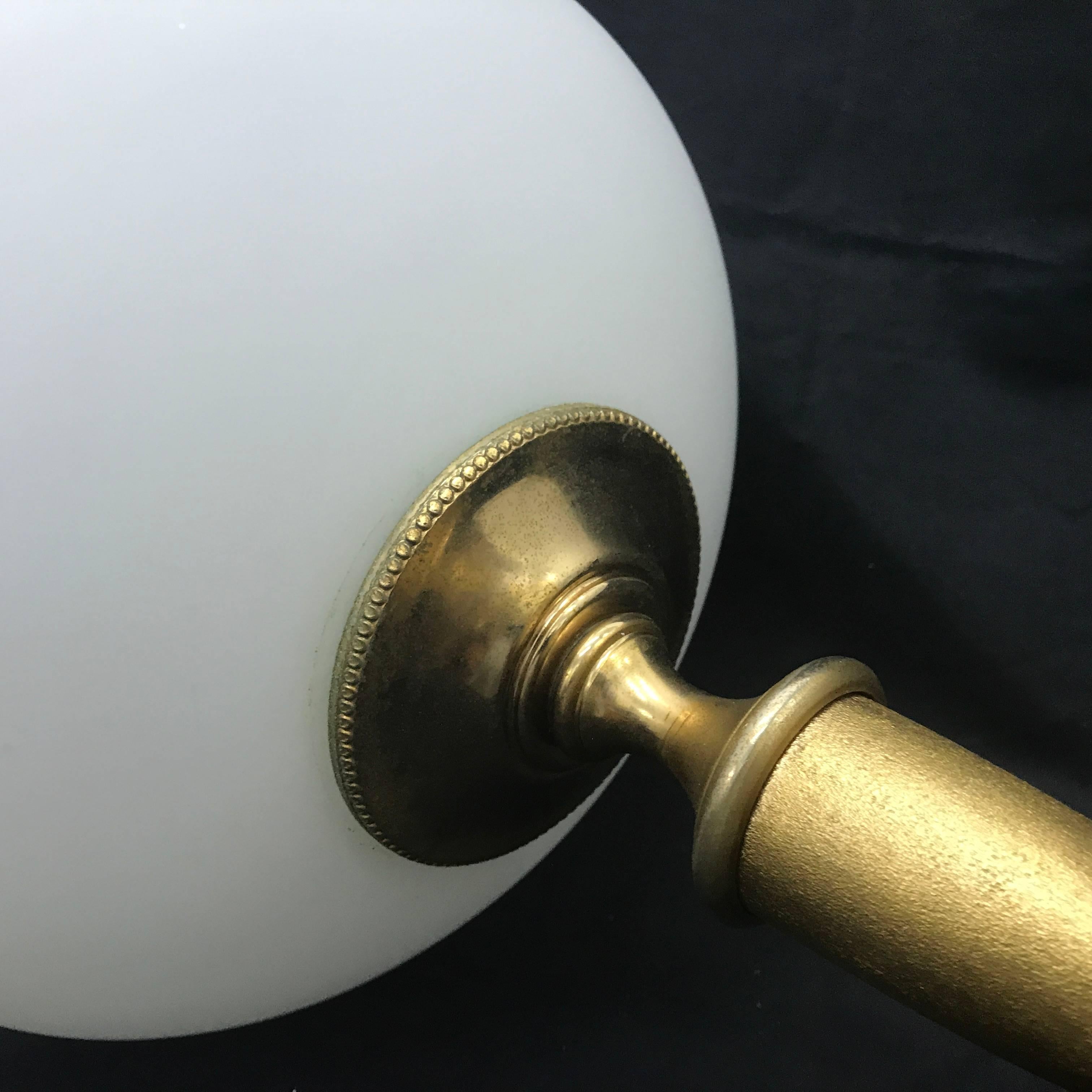 Amazing table lamp, design it's attributed to Guglielmo Ulrich for F.I.L.C. Milano, golden metal and milk glass, original conditions. Fully restored electrical parts, it works 110-240 volts and needs a regular e27 bulb. Made in 1950, it's labeled on