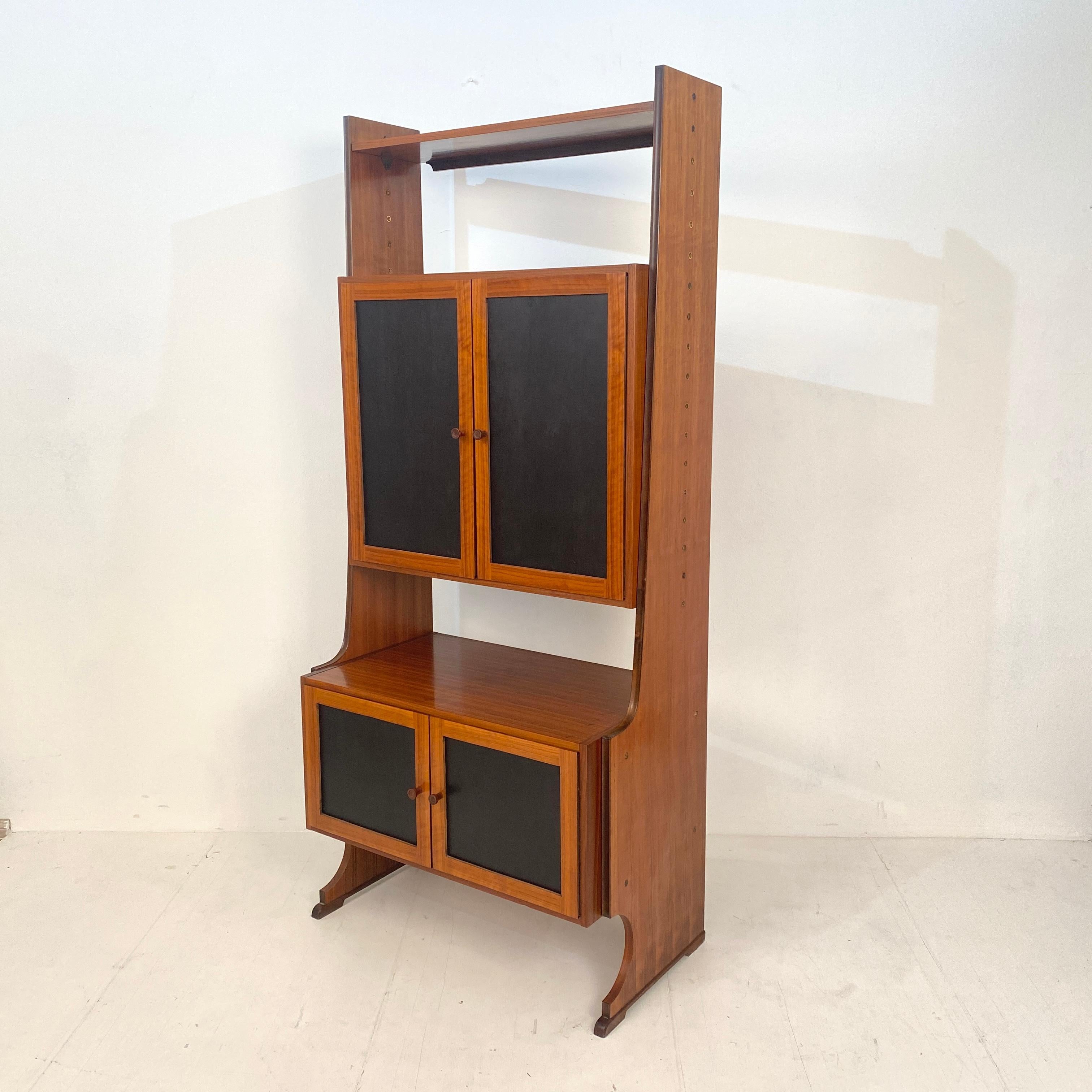 This Mid-Century Modern Italian Shelf / Bookcase was made around 1960.
It is made out of Teak and the two cases has got dark brown / black lacquered wood panels.
A unique piece which is a great eye-catcher for your antique, modern, space age or