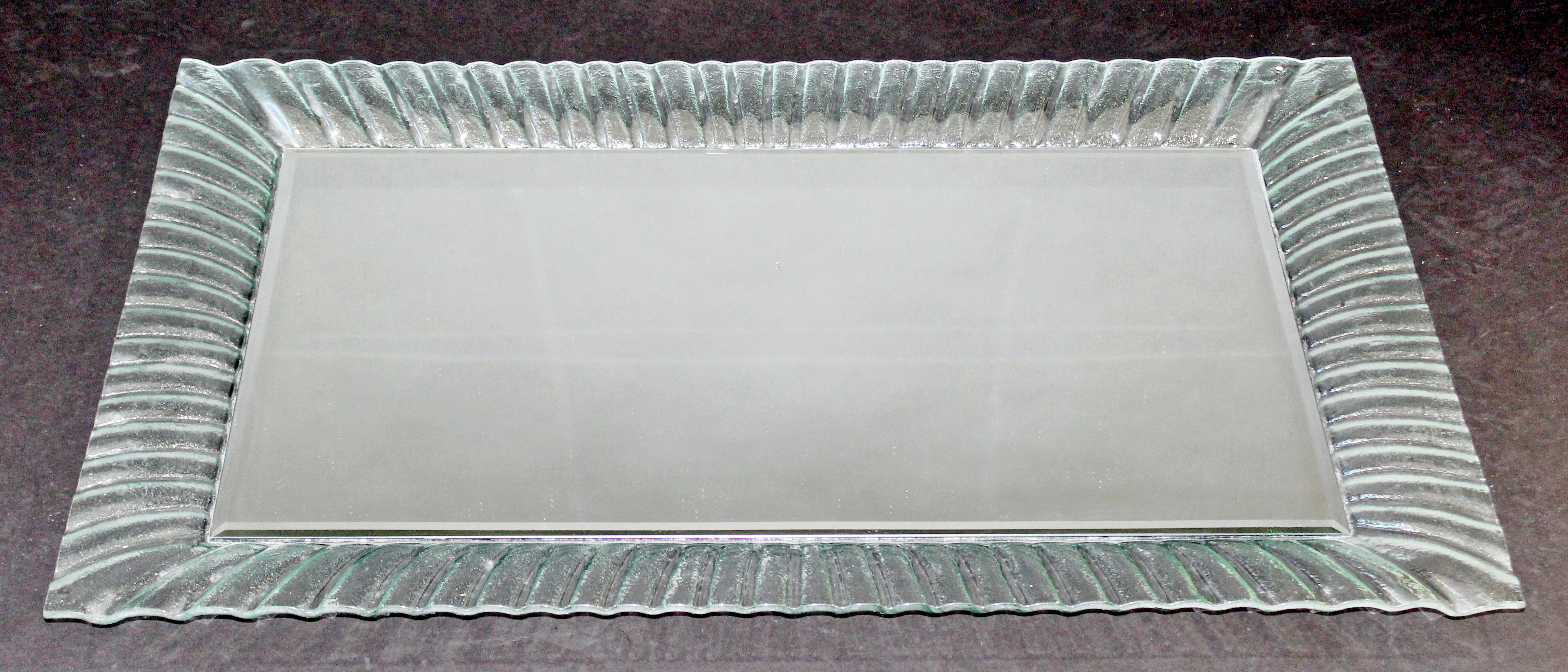 For your consideration is a stunning, rectangular wall mirror, with a textured Murano glass frame, circa the 1960s. In excellent condition, despite one small chip in the mirror. Glass is in excellent condition. The dimensions are 23.5