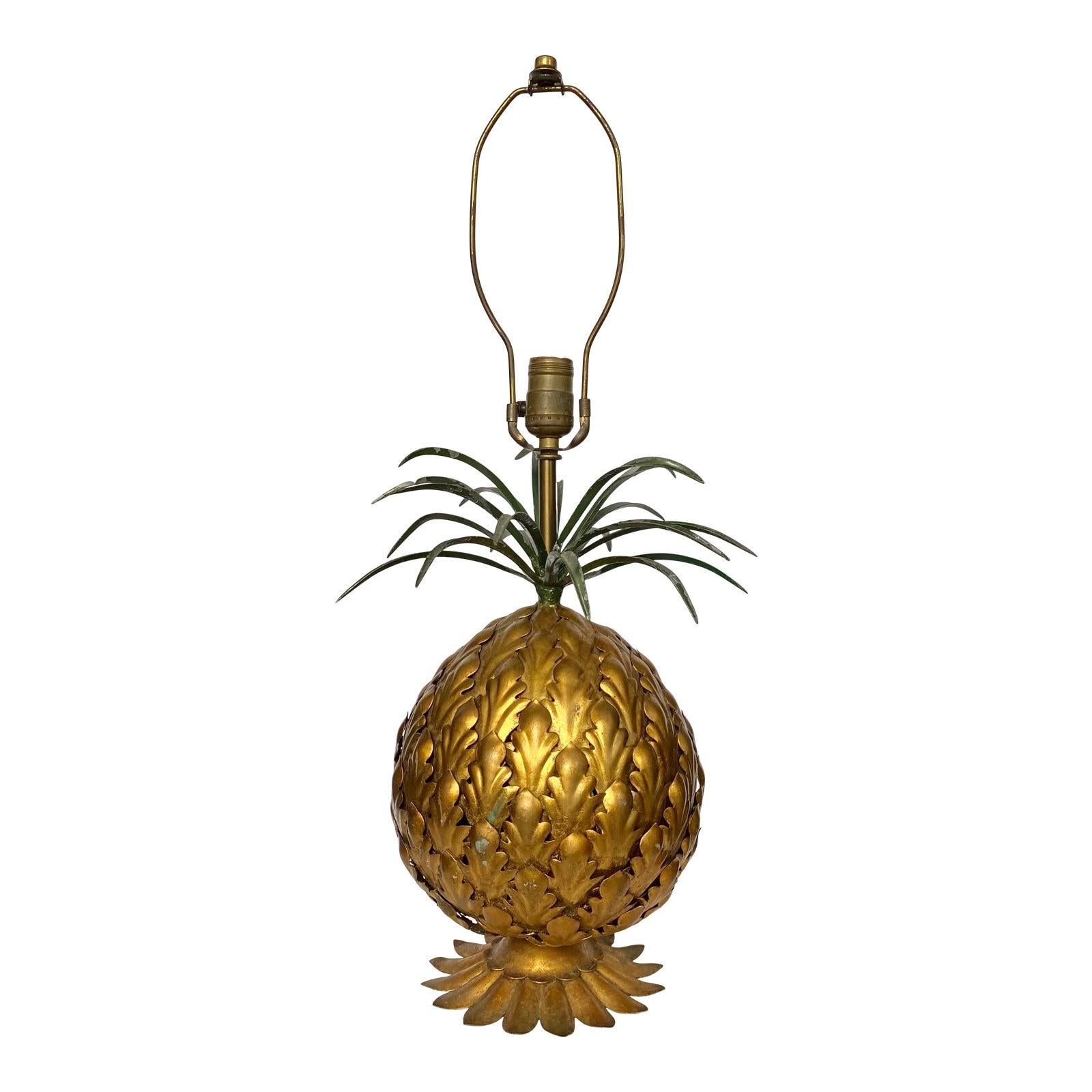 Gorgeous and unique sculptural Italian metal toleware pineapple table lamp. Body of lamp features welded metal fruit pieces in gold toned gilt finish. Metal slip leaves are nicely welded to the base of lamp. The top crown of the lamp features welded