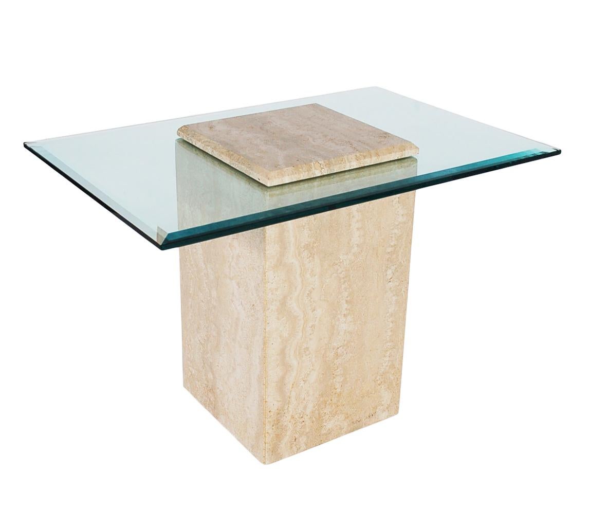 A chic and modern designed side table or cocktail table made in Italy, circa 1978. This table consists of heavy a heavy thick travertine base with a floating clear piece of glass. Very well cared for and ready for immediate use.