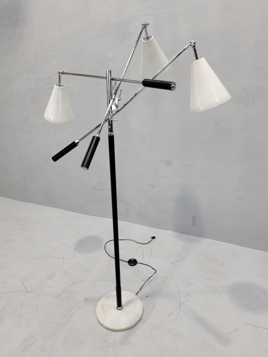 Vintage Mid Century Modern Italian Triennale Floor Lamp Styled after Gino Sarfatti for Arteluce

This classic mid-century modern floor lamp was styled after Gino Sarfatti for Arteluce. It has a marble based and light adjustment handles wrapped in