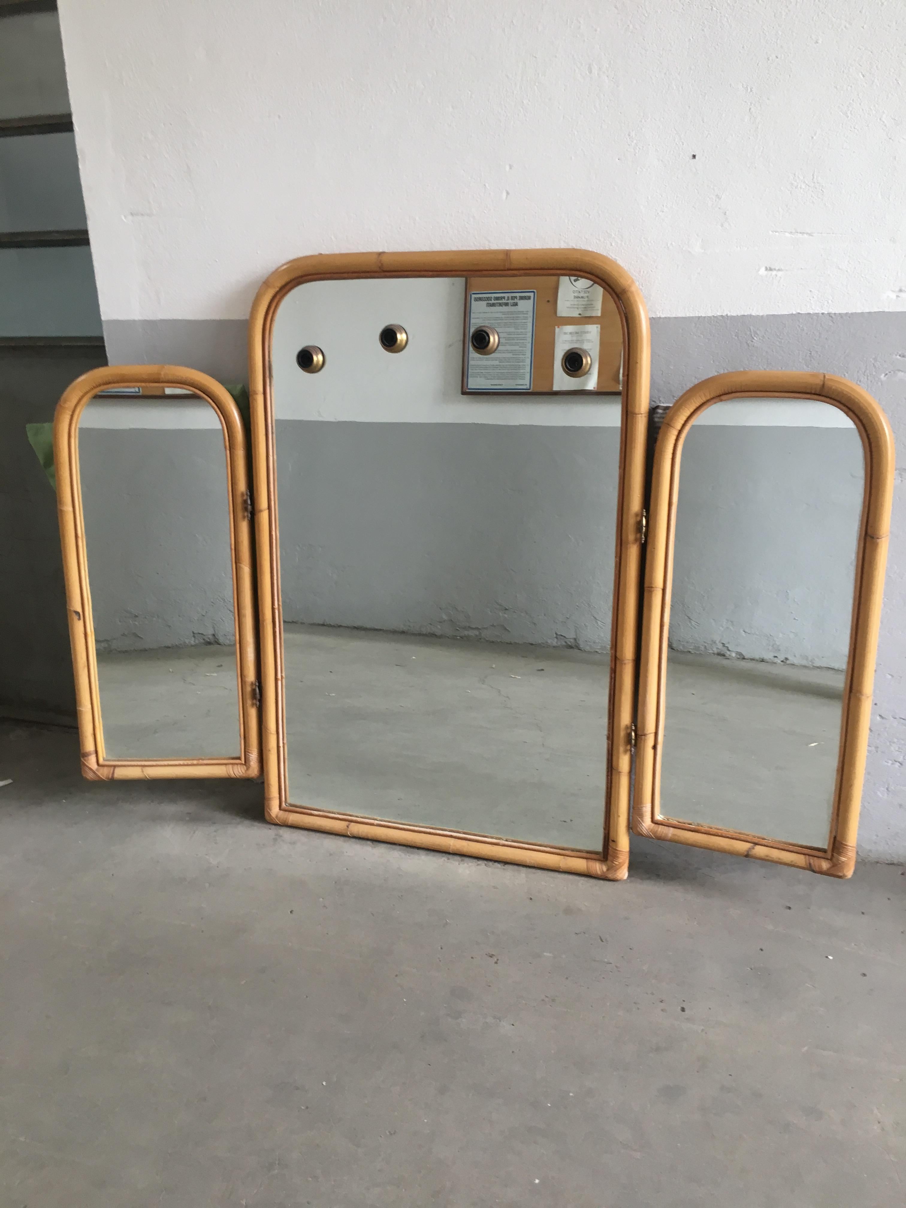Mid-Century Modern Italian triptych bamboo framed mirror. The central panel of this mirror has 4 holes for bulbs light.
Measurements: 
Central mirror cm. 80 x 4 x H 122
Lateral mirrors cm. 40 x 4 x H 90 each.
   