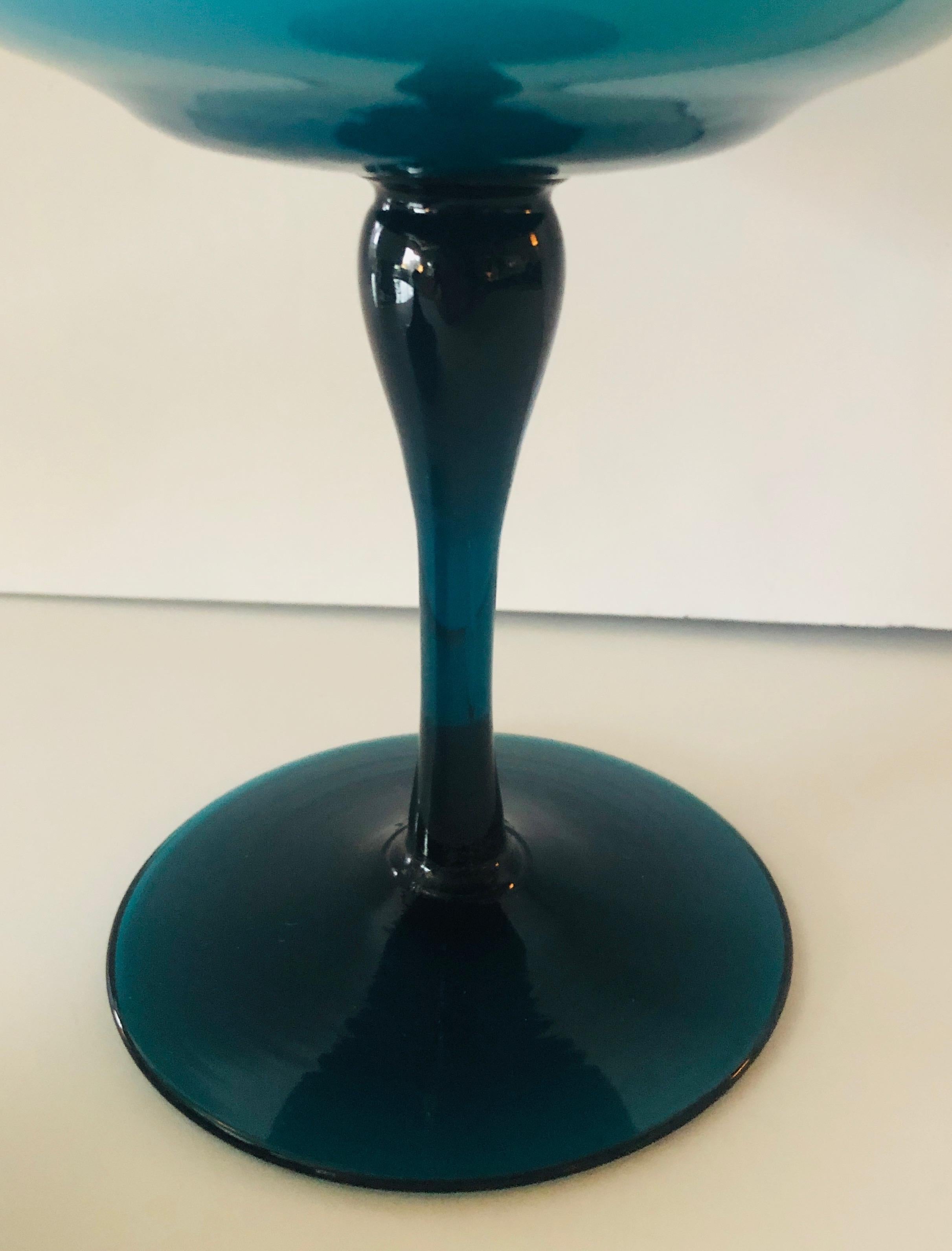 Offered is a Mid-Century Modern Italian turquoise blue Murano glass stemmed blown candy dish with decorative pom pom top lid. This is a beautiful example of Italian craftsmanship and of the hundreds year old tradition of Murano mouth blown glass in