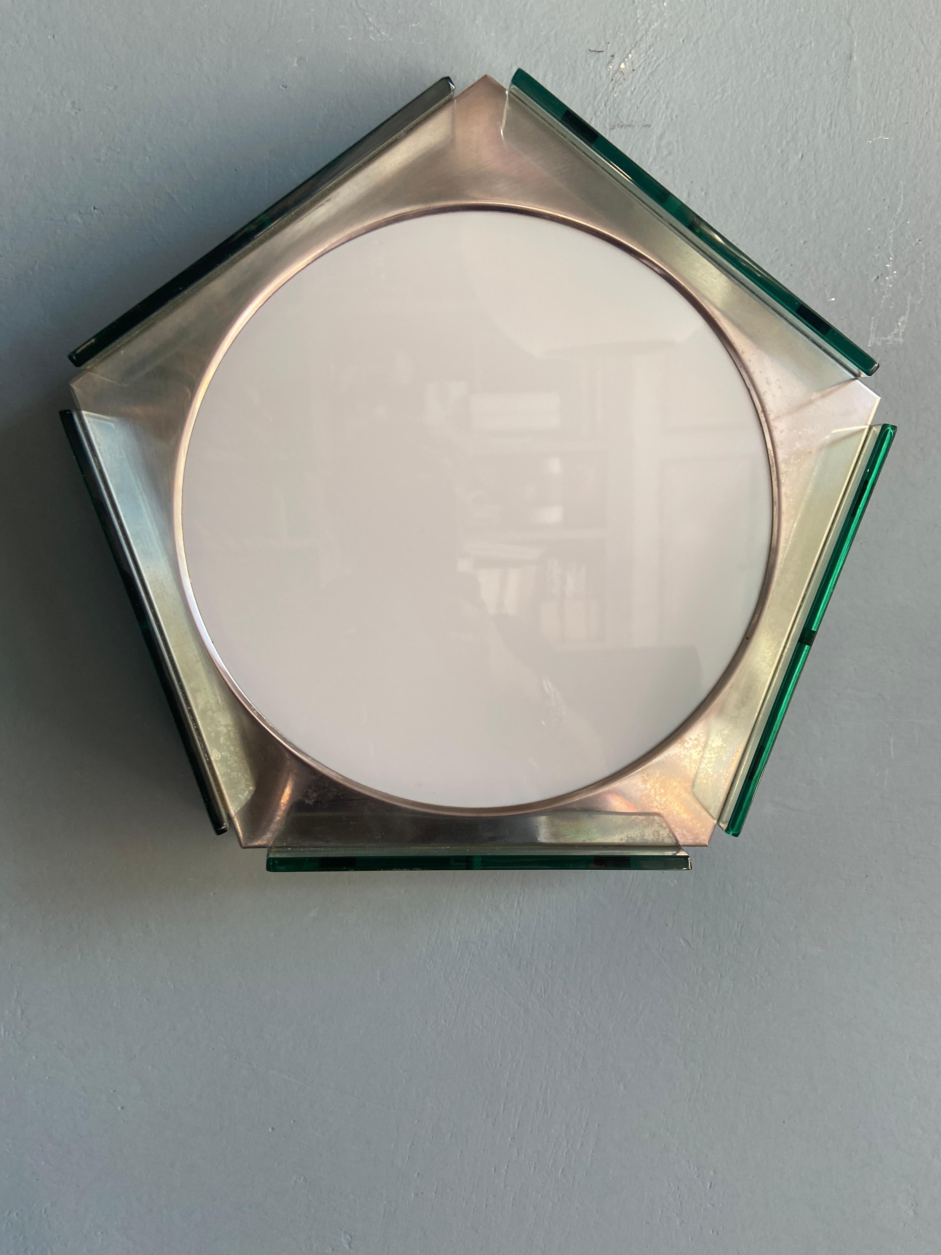 Mid-Century Modern Italian Three-light wall lamp in stainless steel with opaline and green colored glasses.
The electrical system was completely replaced along with the lamp holders