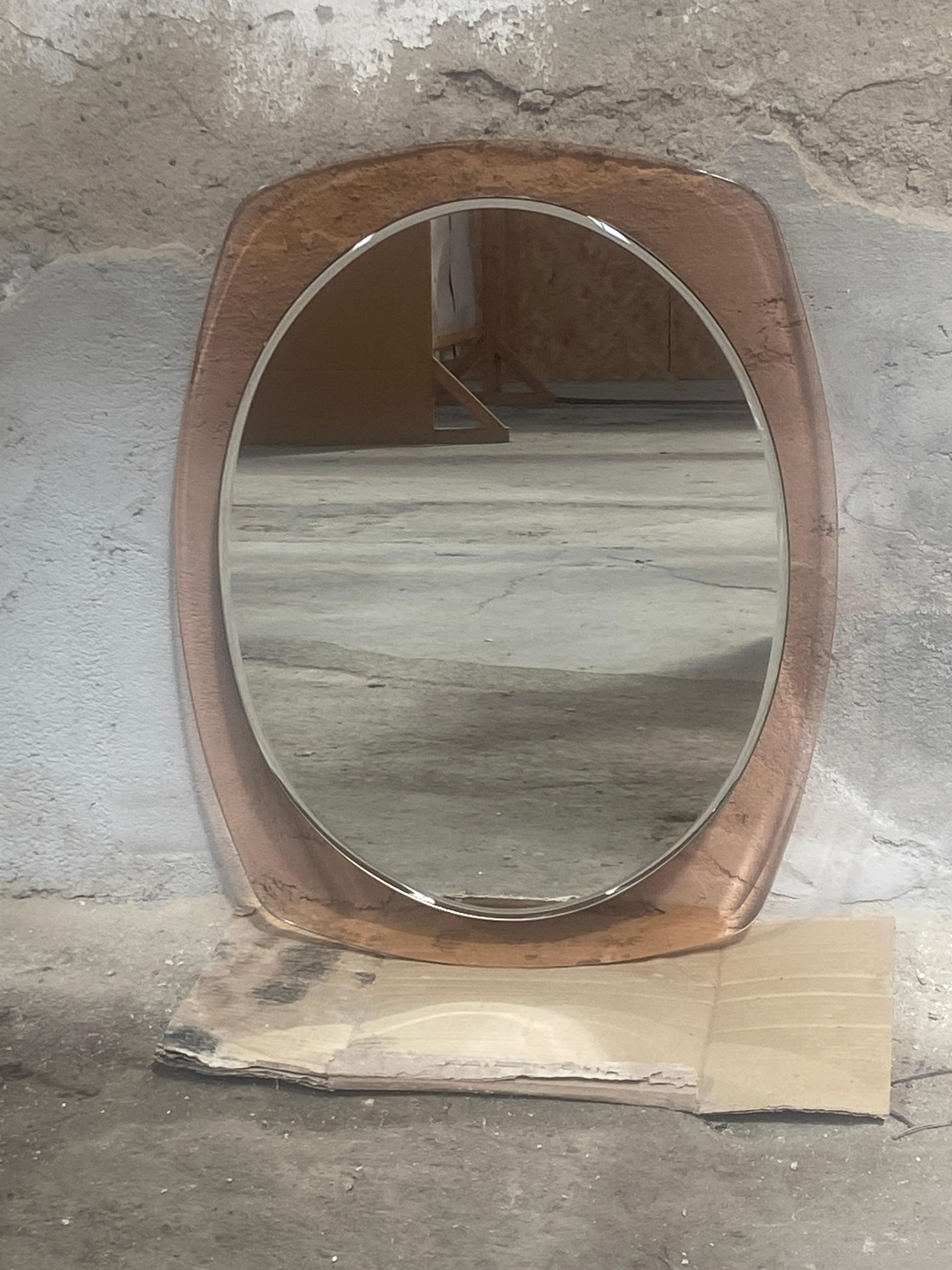 Mid-Century Modern Italian wall mirror with pale rose glass frame by Veca. 1960s
The mirror has a slight grinding.
There is a second mirror available with the same measures and color, but the mirror has not any grind. Cost for the pair on demand