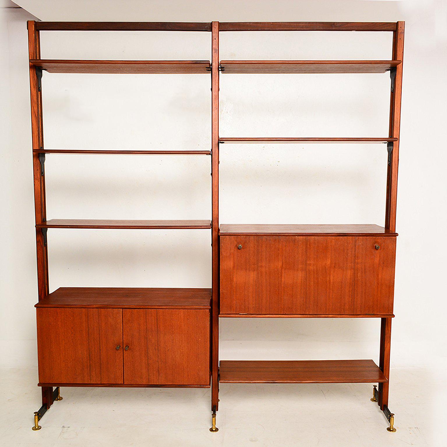 For your consideration a two bay freestanding wall unit, which can serve as room divider. 

Beautiful wood grain unsure of what king of wood. The system has bronze legs in sculptural shape.

Features several shelves and two cabinets. 

Please