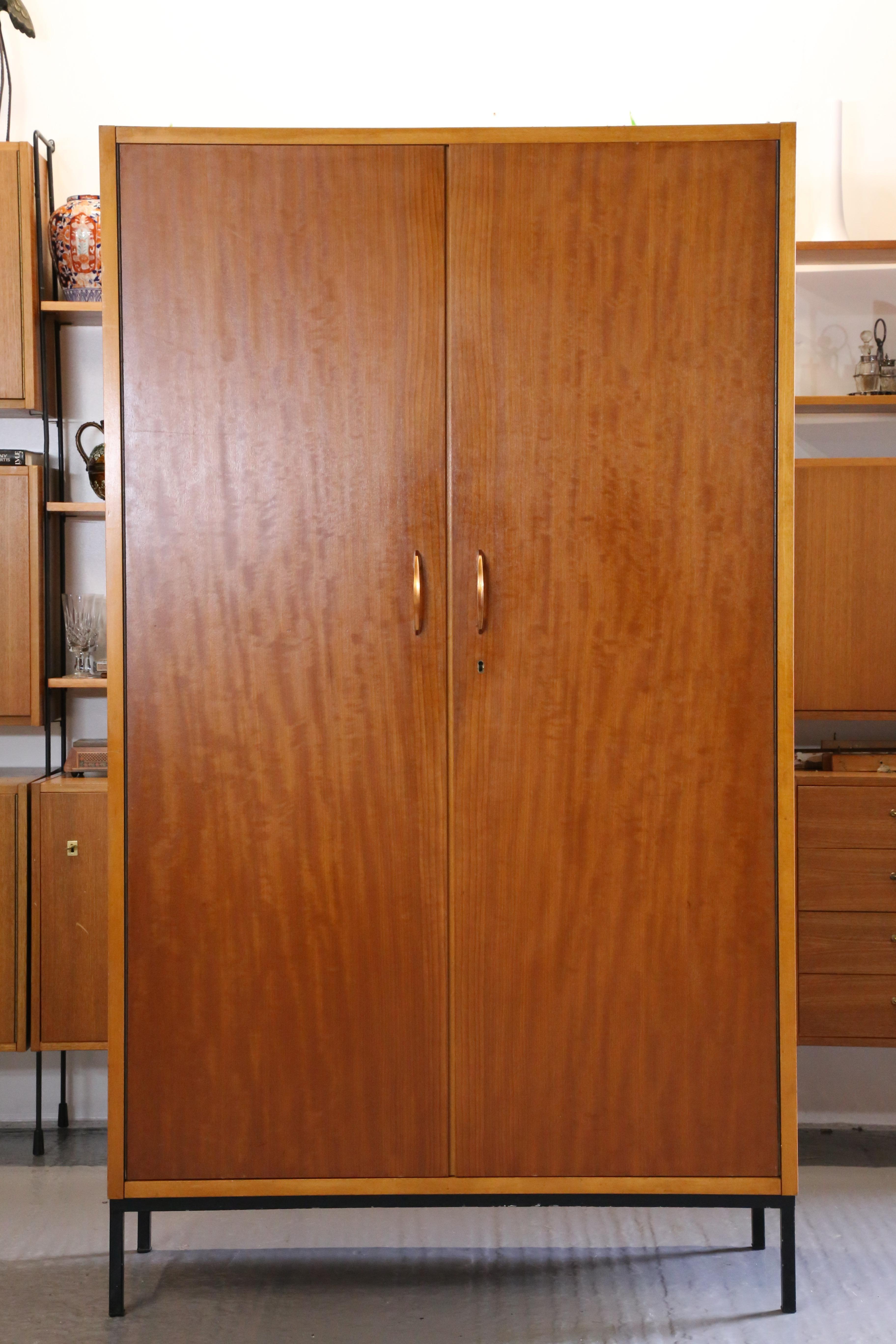 Sophisticated Simplicity: Mid-Century Modern Italian Walnut & Maple Wardrobe / Armoire On Stand by Dal Vera

Elevate your space with the timeless elegance of the Mid-Century Modern Italian Walnut & Maple Cupboard On Stand crafted by the esteemed