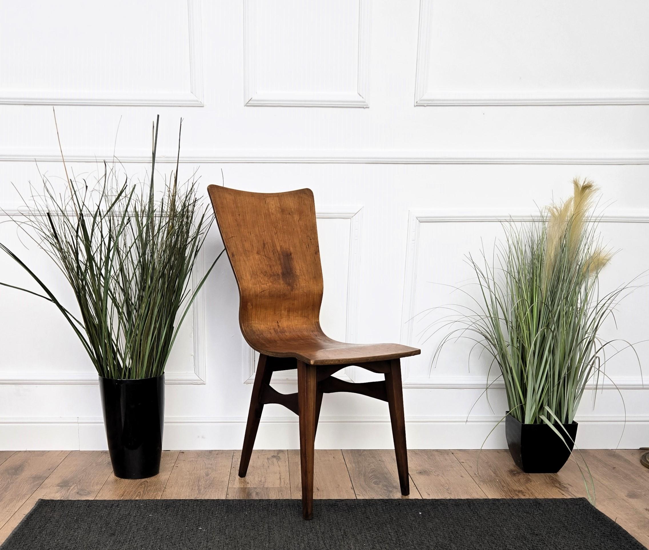 Very elegant and classic Mid-Century Modern Italian walnut wood chair. This chair will bring a touch of MCM craftsmanship refinement to any living room, bedroom or office room. The unique and typical design, with the typical side shape and the