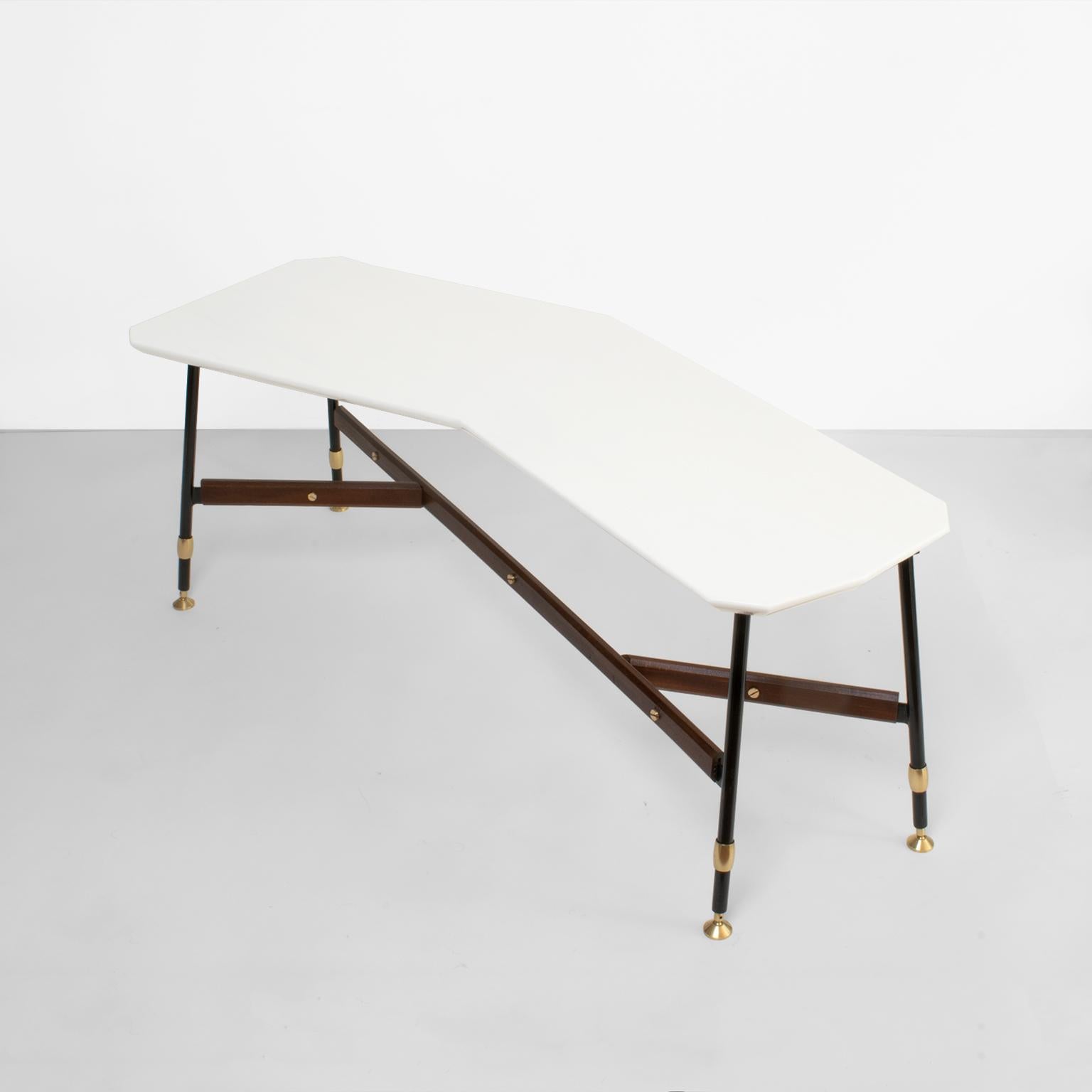 An elegant Mid-Century Modern Italian coffee table with a polished white marble top with 11 angles and a reverse bevel edge. A lacquered metal base with polished brass feet and screws accent a the teak wood brace. Newly restored in excellent