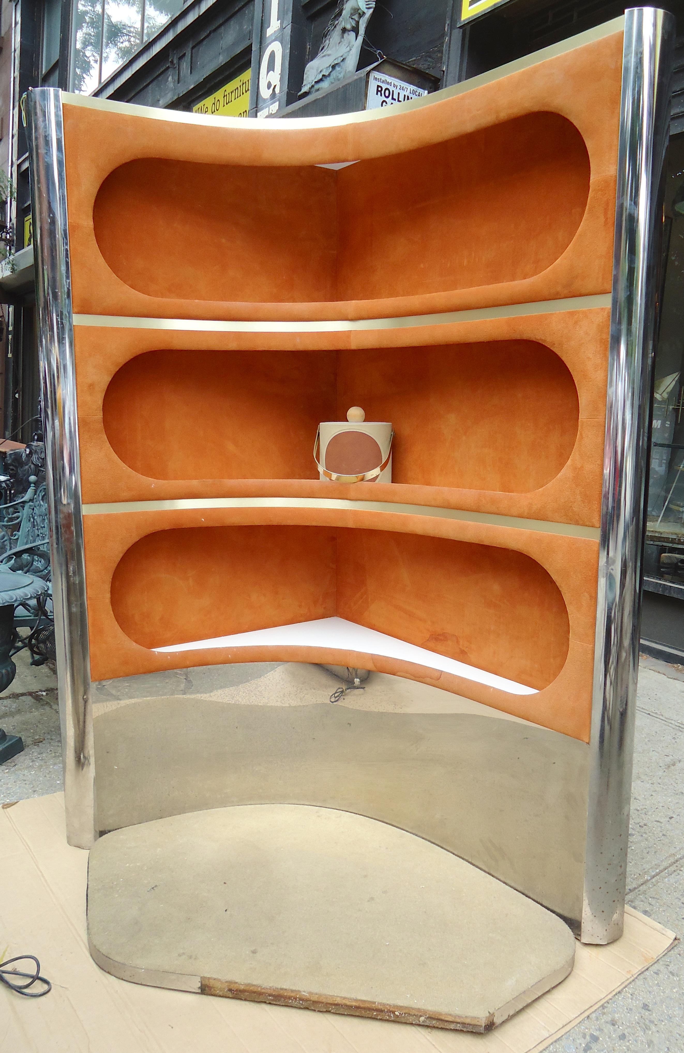 Fantastic two-piece corner bar with suede trim and mirrored glass counter top. Back bar is wired with lights, front bar has storage and refrigerator unit with European plug.
Measures: Back bar: 48
