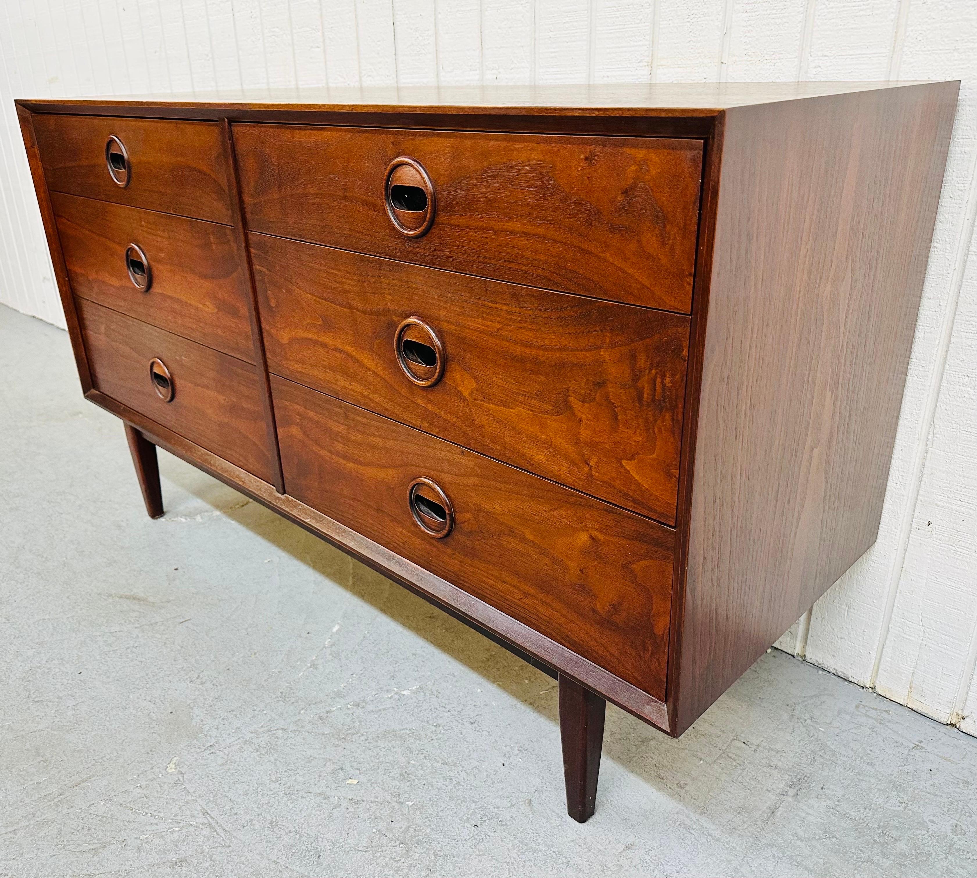 This listing is for a Mid-Century Modern Walnut Dresser attributed to designer Jack Cartwright. Featuring six drawers for storage, round sculpted walnut pulls, and a beautiful walnut finish. This is an exceptional combination of quality and design.