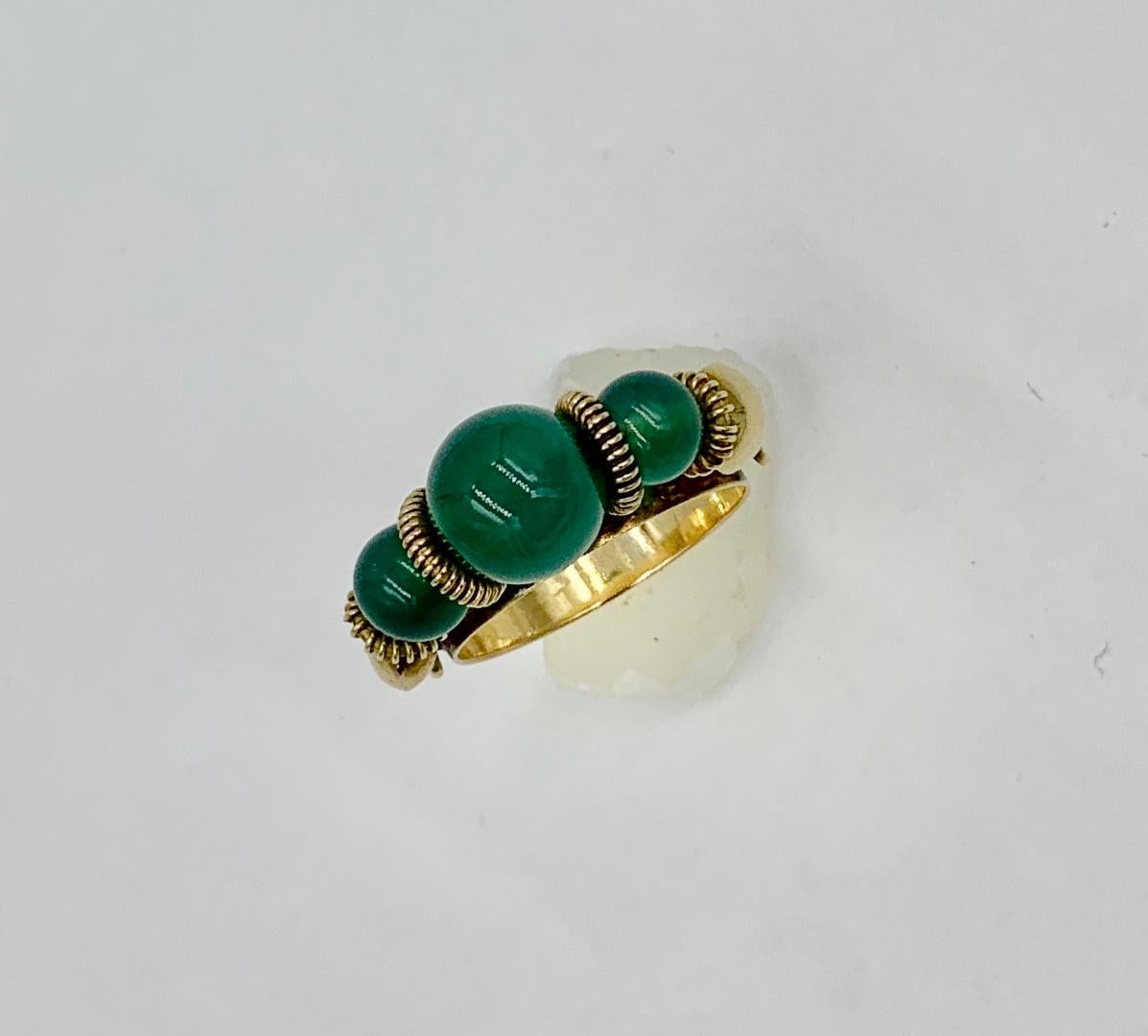 A wonderful Mid-Century Modern Jadeite Jade Ring with stunning Jade Beads which spin along the top of the ring in 18 Karat Yellow Gold.  The ring is just wonderful and in a Moghul style.  The Jade beads are interspersed with 18 Karat Gold coils. The