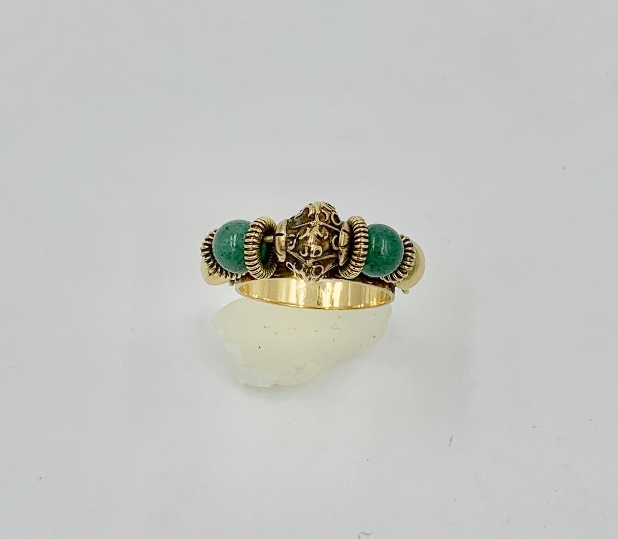 A wonderful Mid-Century Modern Jadeite Jade Ring with stunning 18 Karat Gold and Jade Beads which spin along the top of the ring in 18 Karat Yellow Gold.  The ring is just wonderful and in a Moghul style.  The Jade beads are interspersed with 18