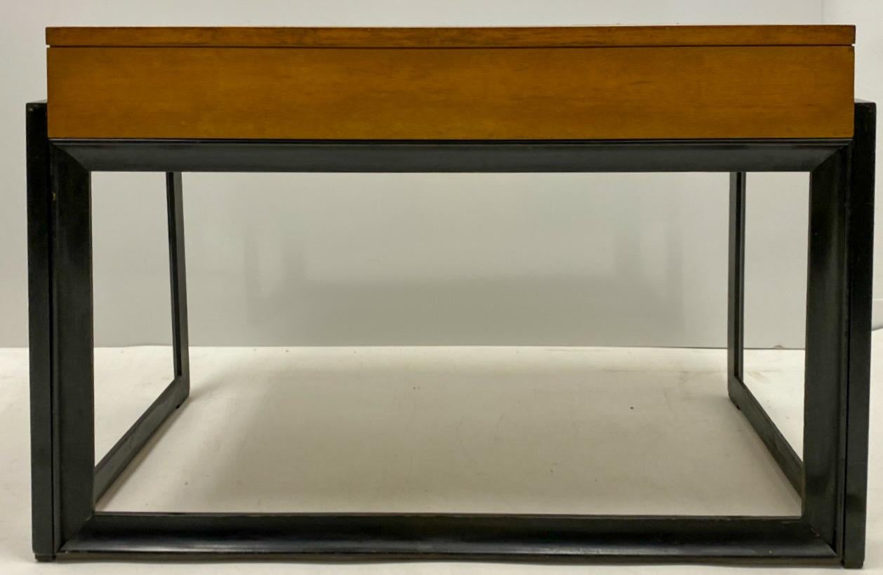 Extra handling time for this piece!

This is a mid-century modern James Mont style style desk or vanity by Johnson Brothers. It is marked and has the original brass hardware that has an Asian flare. The Birds Eye maple case rests on an ebony base.