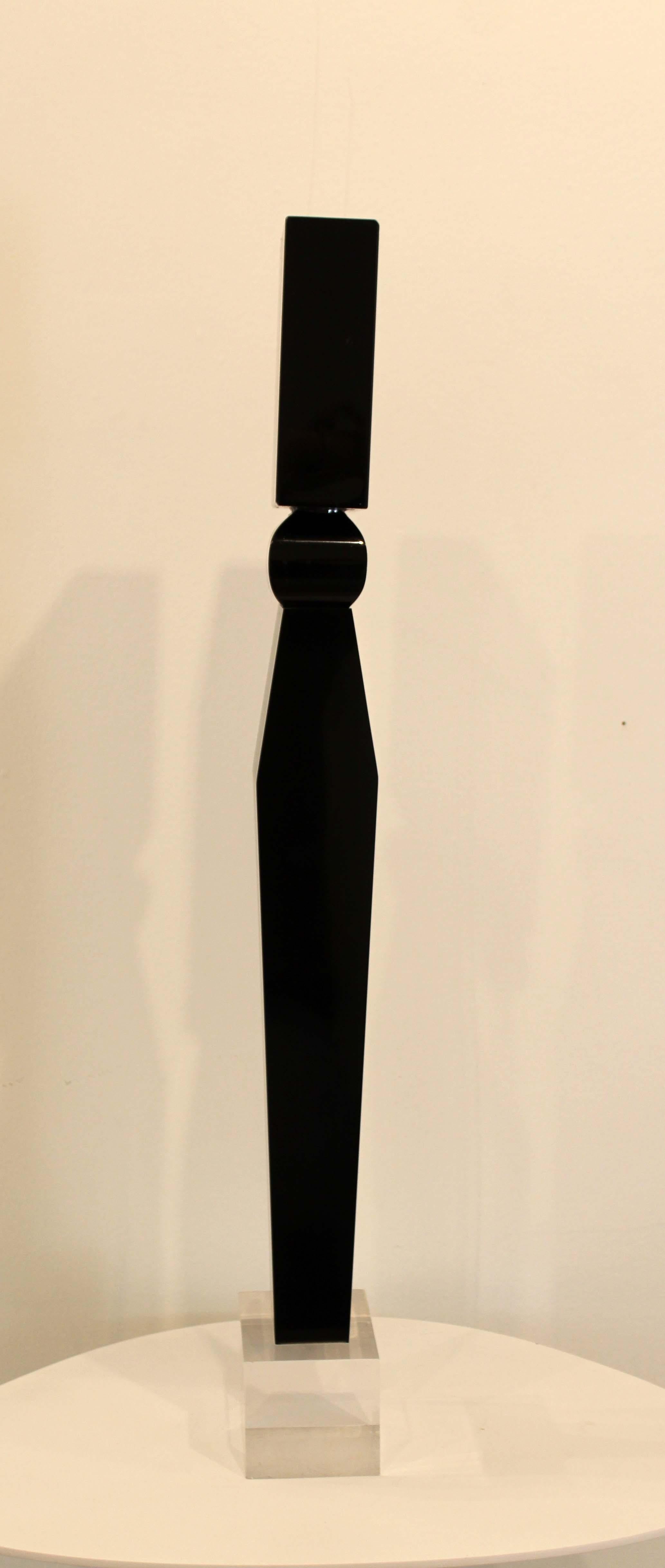 A stunning, monolithic, sleek sculpture depicting a modern black pillar by Detroit sculptor James Nani. This sculpture would be lovely in a modern or Art Deco inspired space. Circa 1970s. Dimensions: 26.5 H x 3 D x 4.5 W. In excellent vintage