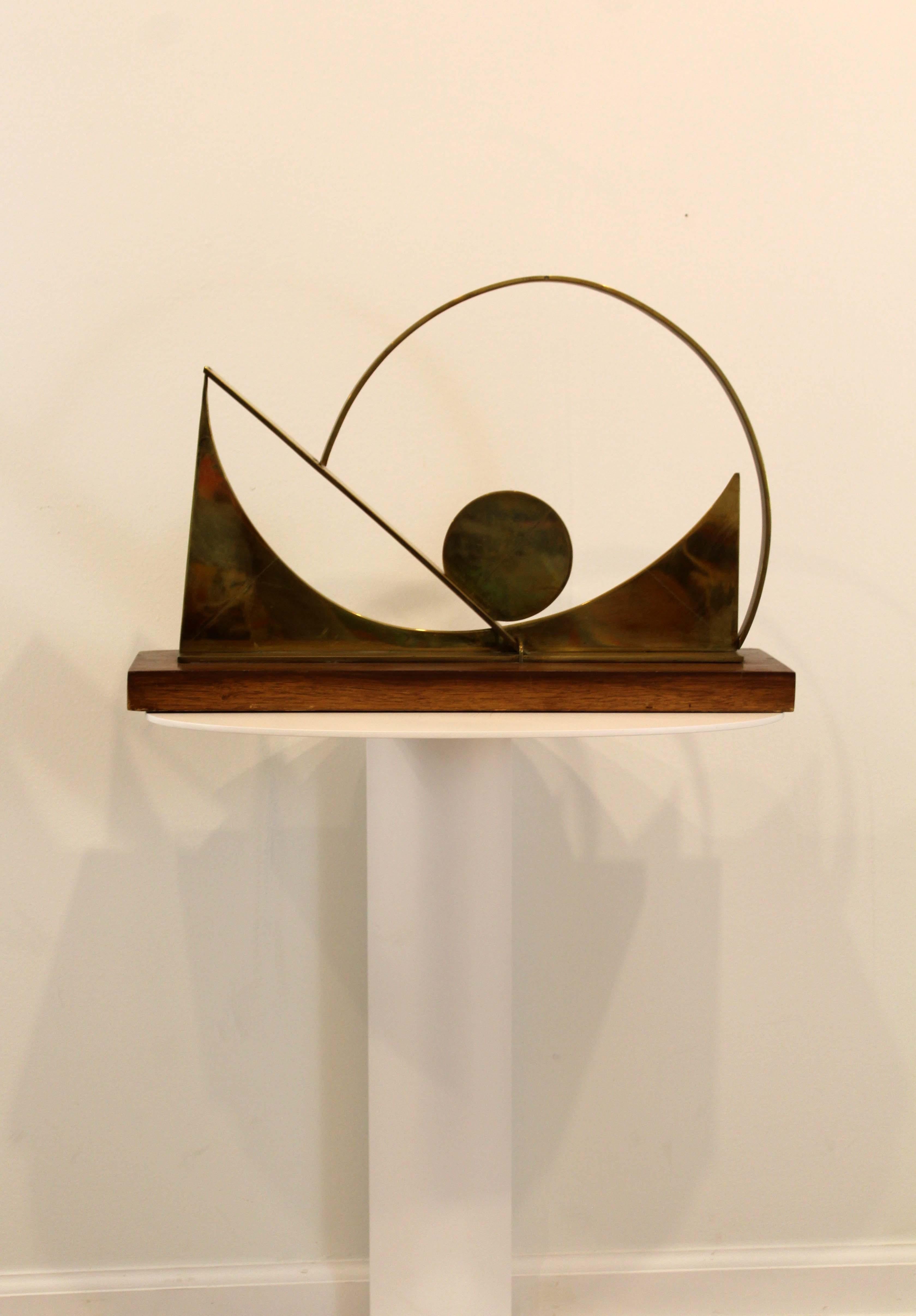 A breathtaking modern geometric sculpture made of brass and wood by Detroit sculptor James Nani. This sculpture has dynamic shapes that create a sense of movement. Circa 1970s. Dimensions: 13 H x 5.75 D x 19.75 W. In excellent vintage condition.