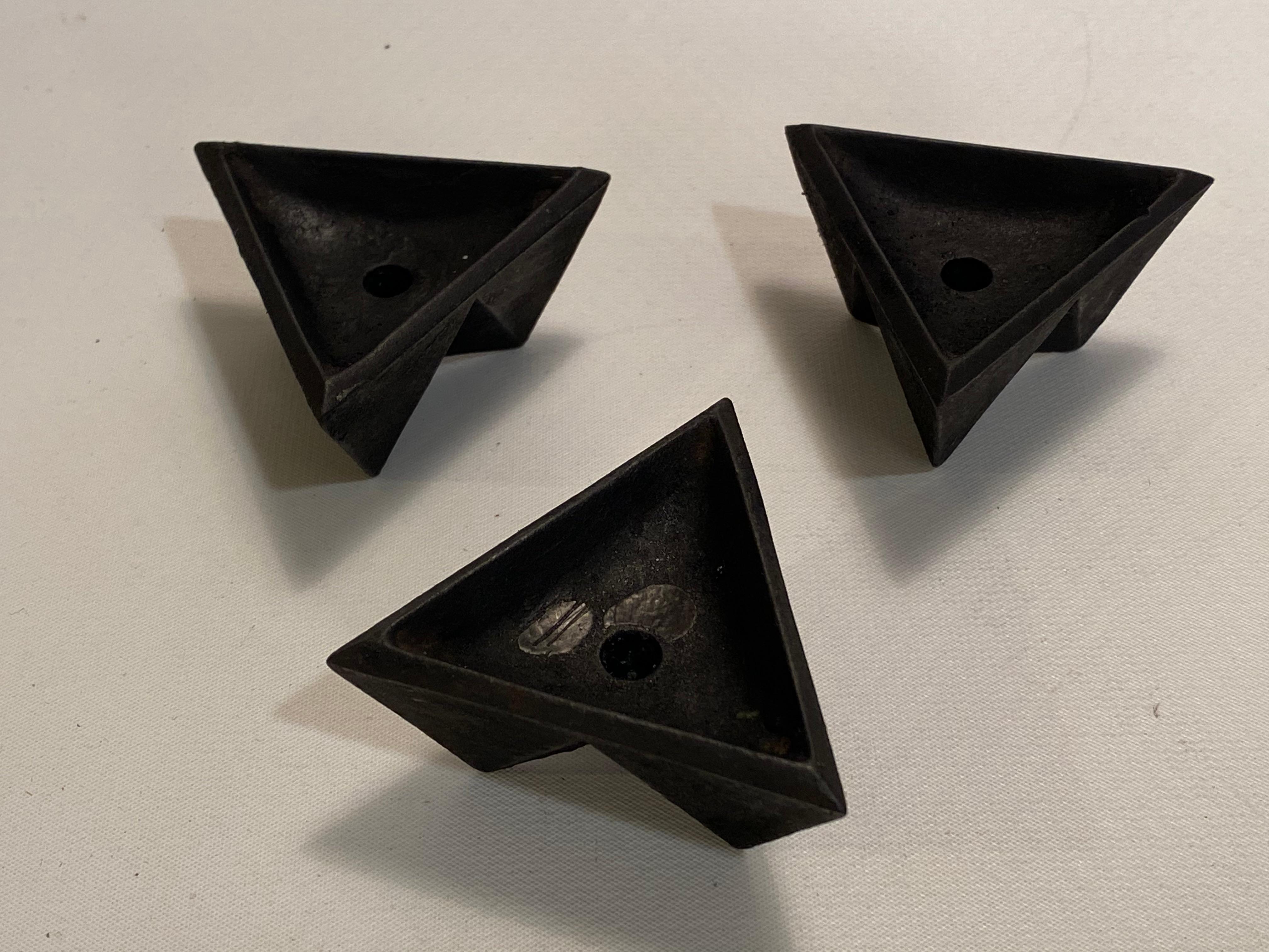 A set of three cast iron origami style candle holders. Geometric pattern that resembles the ancient art of folded paper creations. The holders take the very delicate Danish style taper candle and create a wonderful dramatic candle light grouping.