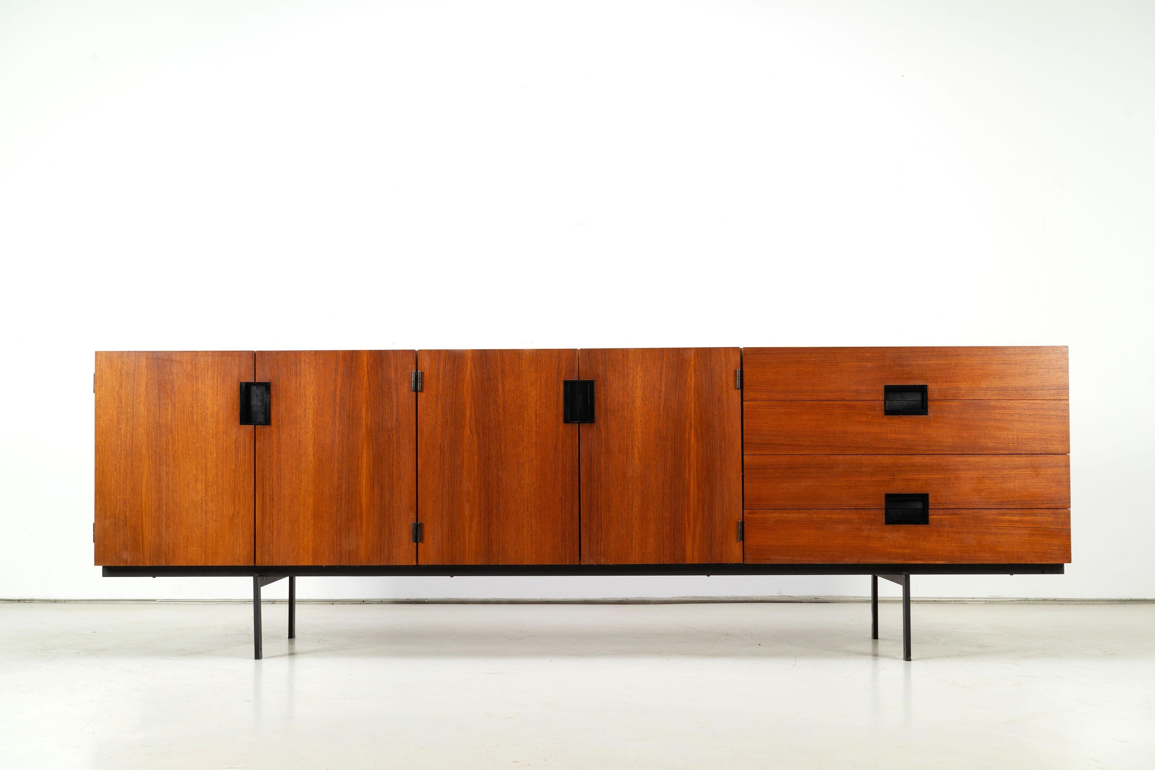 Beautiful sideboard model DU 03 from the Japanese Series by Cees Braakmann for UMS Pastoe. Designed in 1958 this piece of furniture features an impressive teak corpus with large black handles one a fine black steel base.