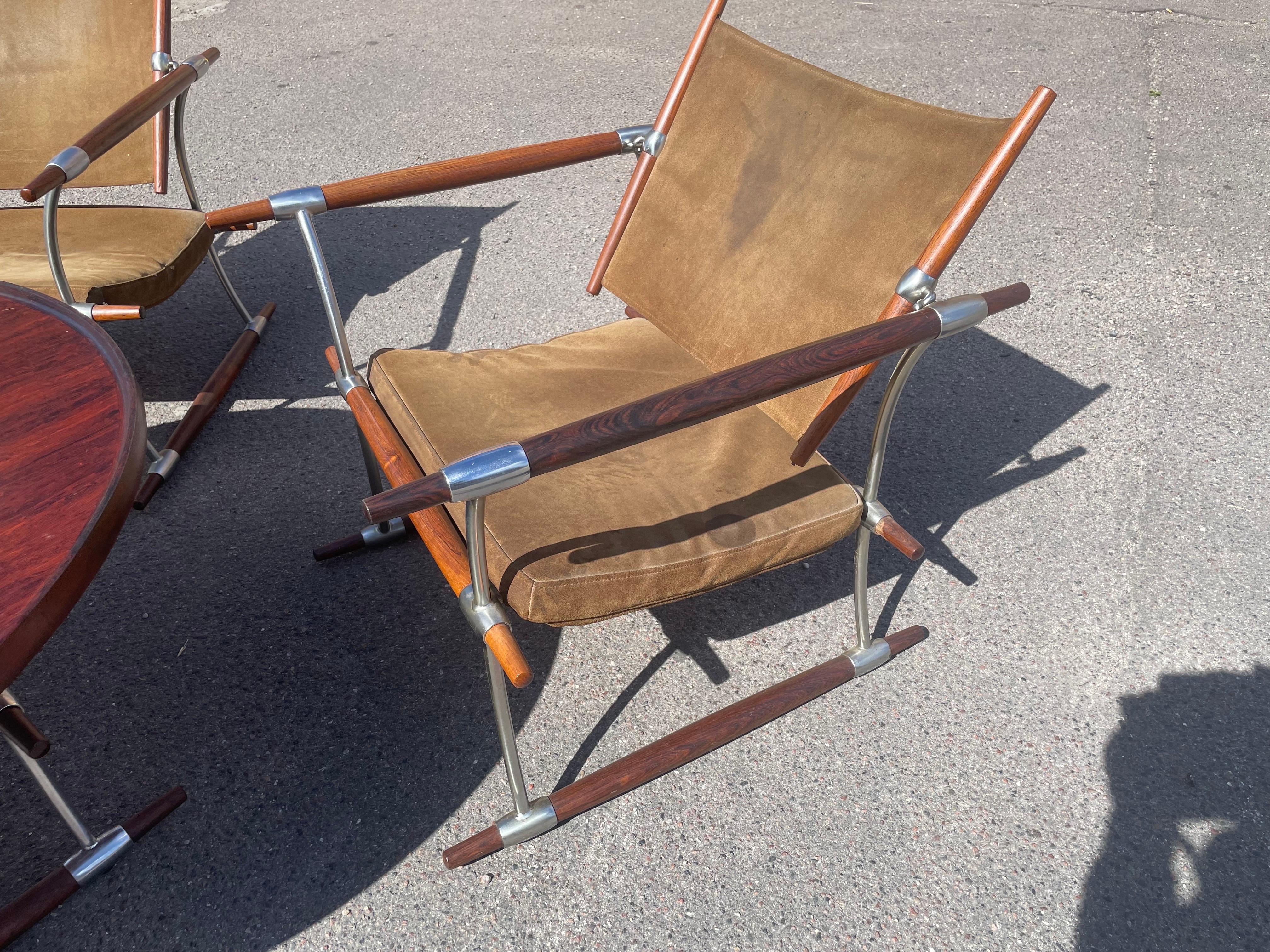 Rare and unparalleled quality craftsmanship by Jens Quistgaard with this exquisite lounge set. The two lounge chairs, designed for ultimate comfort and style, feature elegant wood grain throughout. They are perfectly complemented by a stunning but