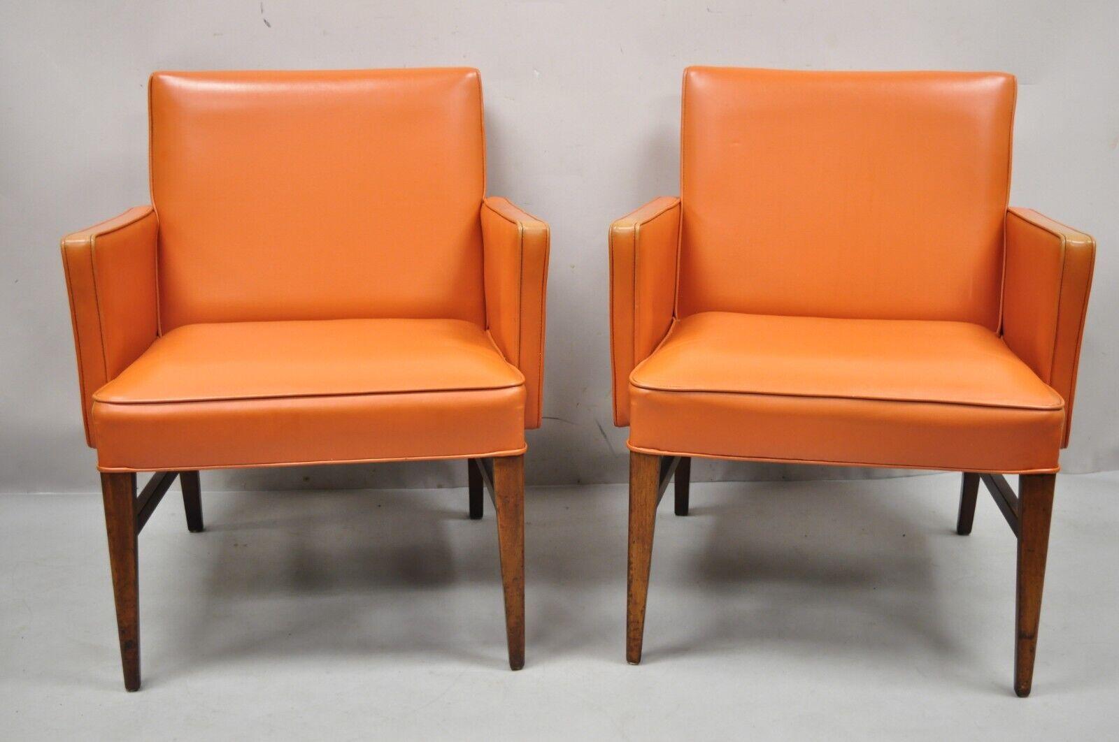 Mid-Century Modern Jens Risom style orange vinyl club lounge chair - a pair. Item features original orange Naugahyde upholstery, solid wood frames, tapered legs, clean Modernist lines, very nice vintage pair. Circa mid-20th century. Measurements: