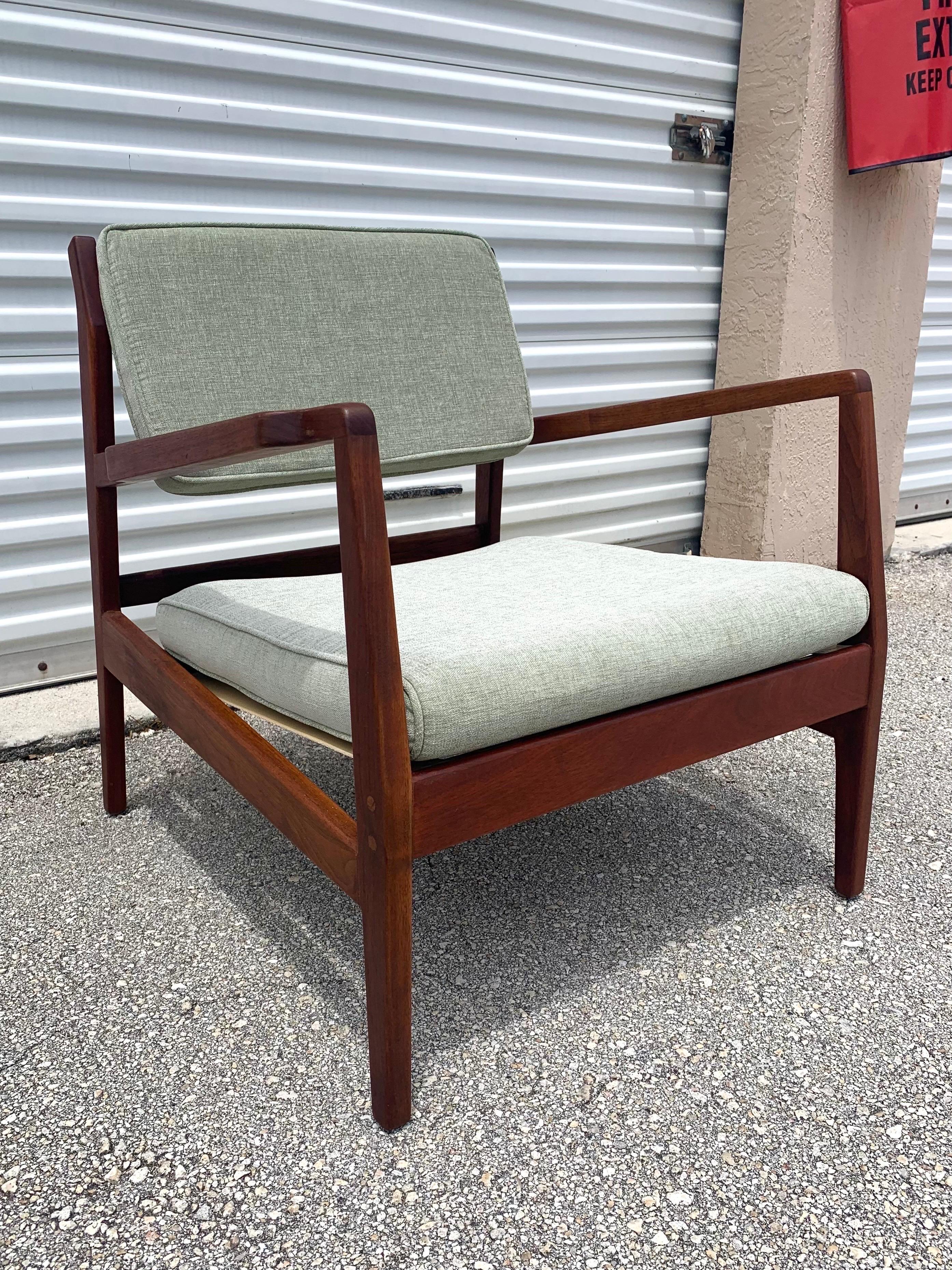Jens Risom U 460 lounge chair. Solid, fully restored, walnut frame and new upholstery and strapping. This chair is ready to last another 60 years. Very comfortable and make a great accent chair for you and your guests. Upholstery is a sage green