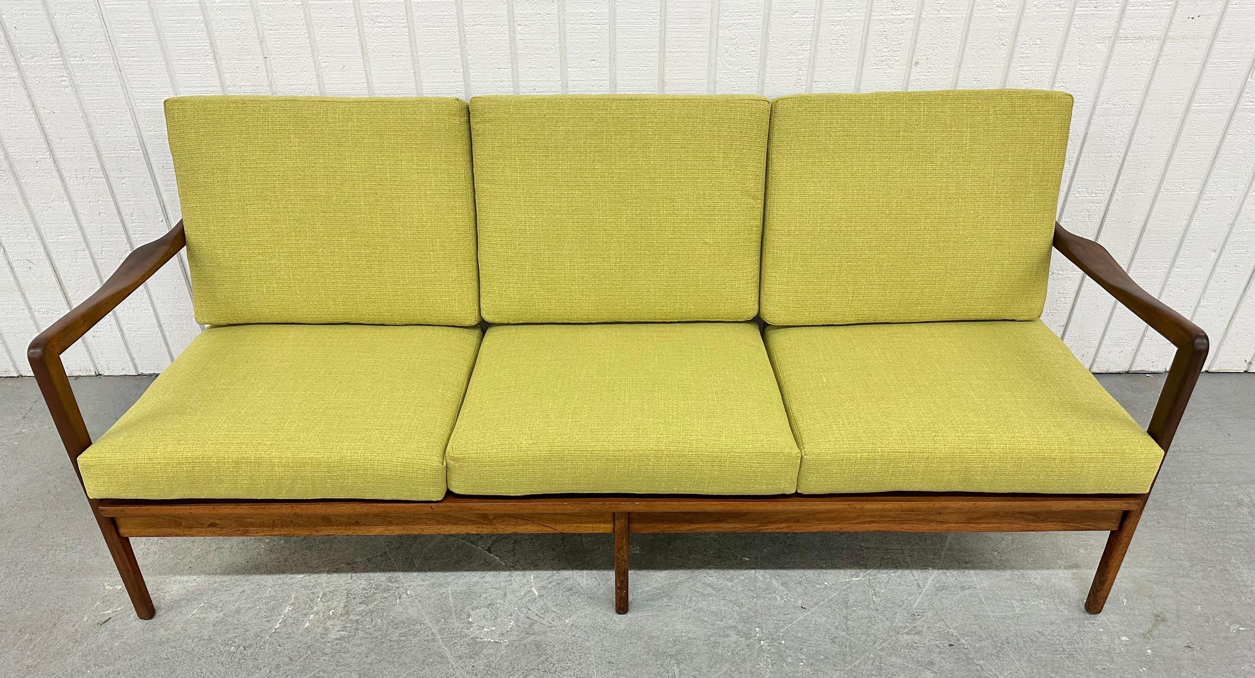 This listing is for a Mid-Century Modern Walnut Sofa. Featuring a thick walnut frame, arms on each side, wooden back spindles, modern legs, new cushions, new straps for support, and a beautiful walnut finish. This is an exceptional combination of