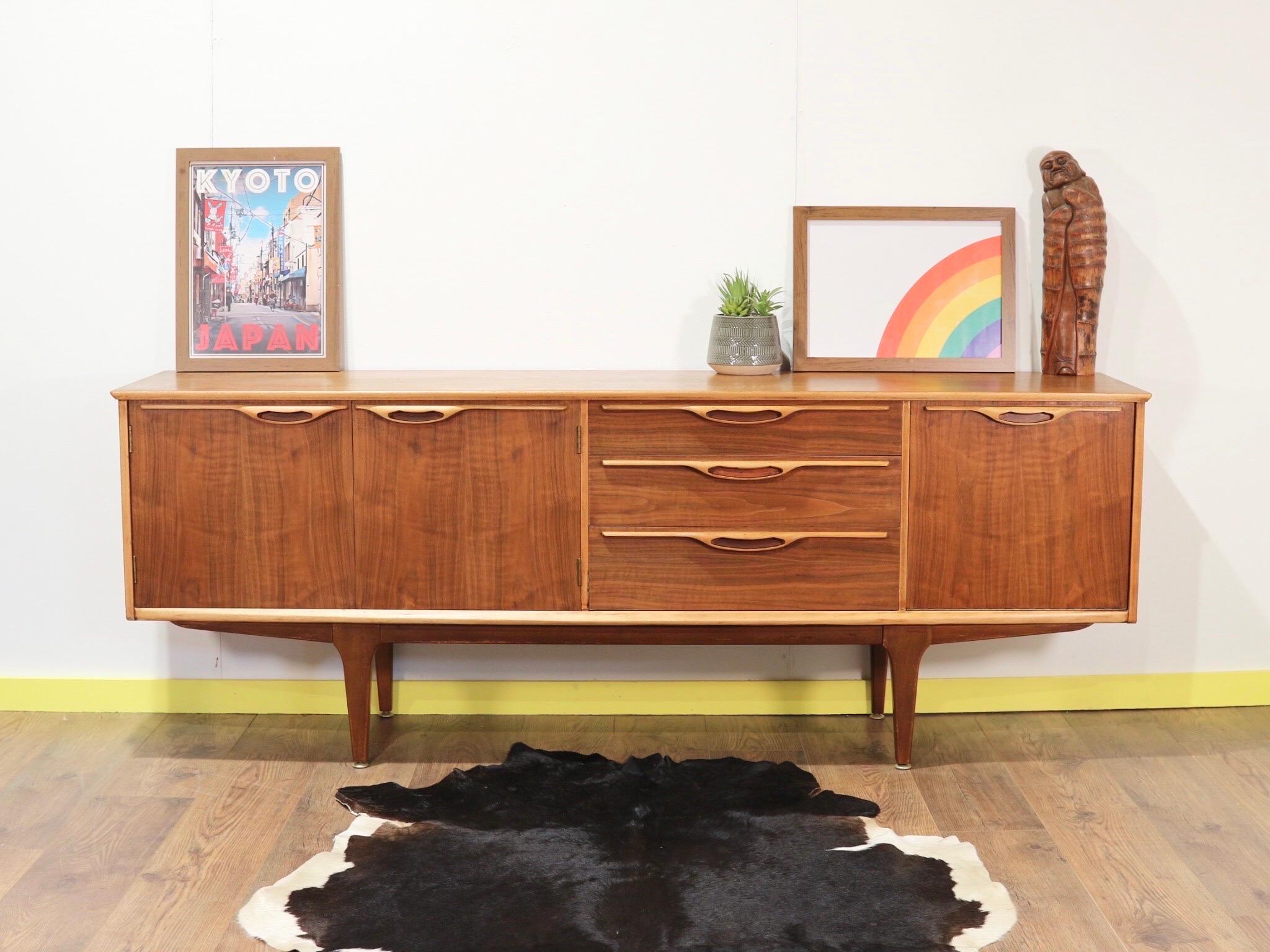 This stunning mid-century crednza was produced by Jentique in England during the 1950s1960s. It has fantastic grain with gorgeous handles to the drawers and flanking cabinet and drinks storage.

A real head turner this would look amazing in any