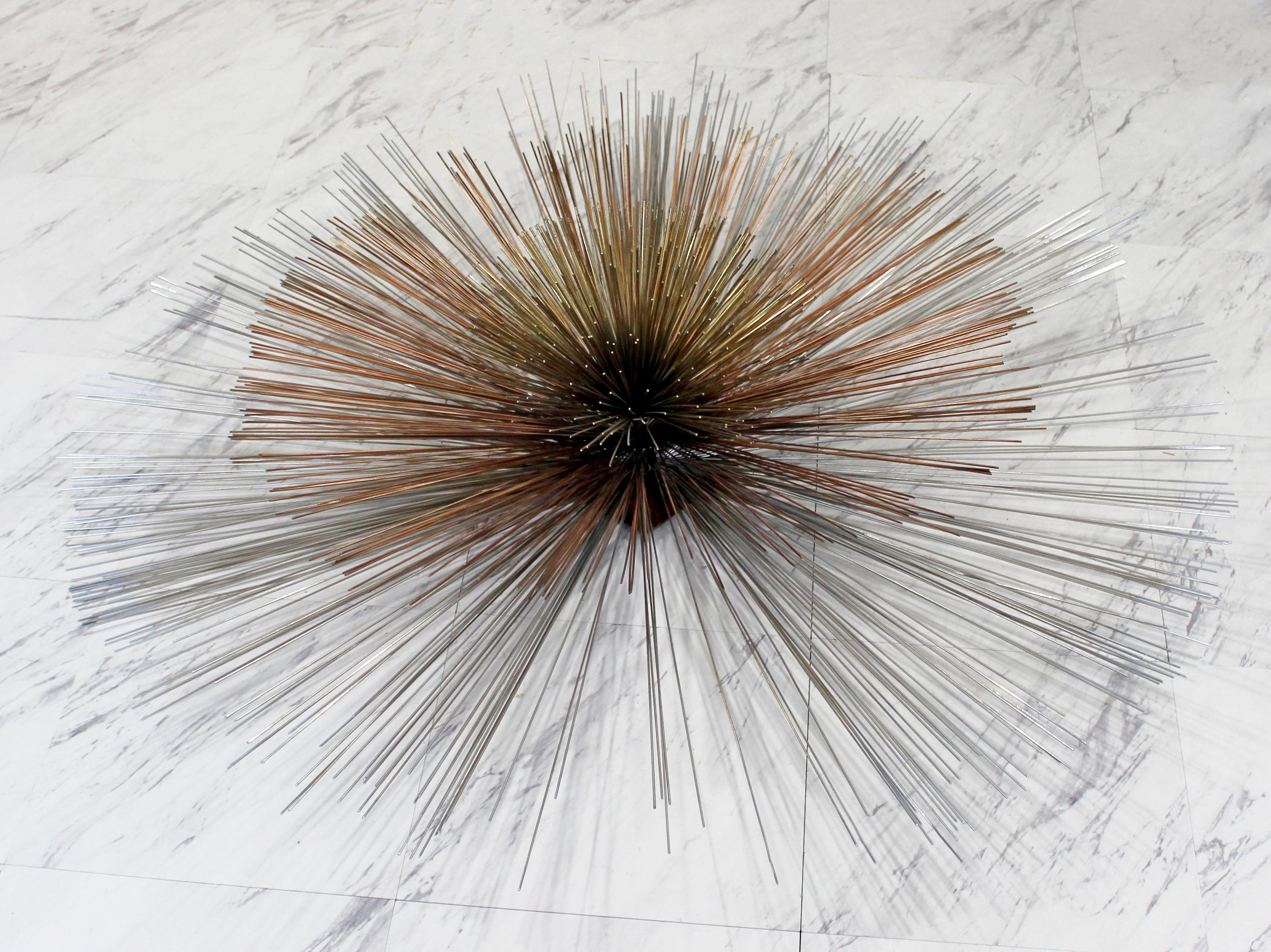For your consideration is a beautiful, large wall Curtis Jere sculpture, reminiscent of a starburst or sunburst, made of copper and metal, circa the 1970s. In excellent condition. The dimensions are 40