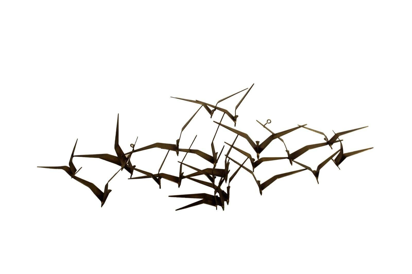 This is a beautiful and original signed C. Jere 'Birds in Flight' metal Brutalist wall sculpture dated 1968. Made of solid brass with sculpted birds, this piece is an iconic and Classic Mid-Century design. in excellent condition. Dimensions: 56