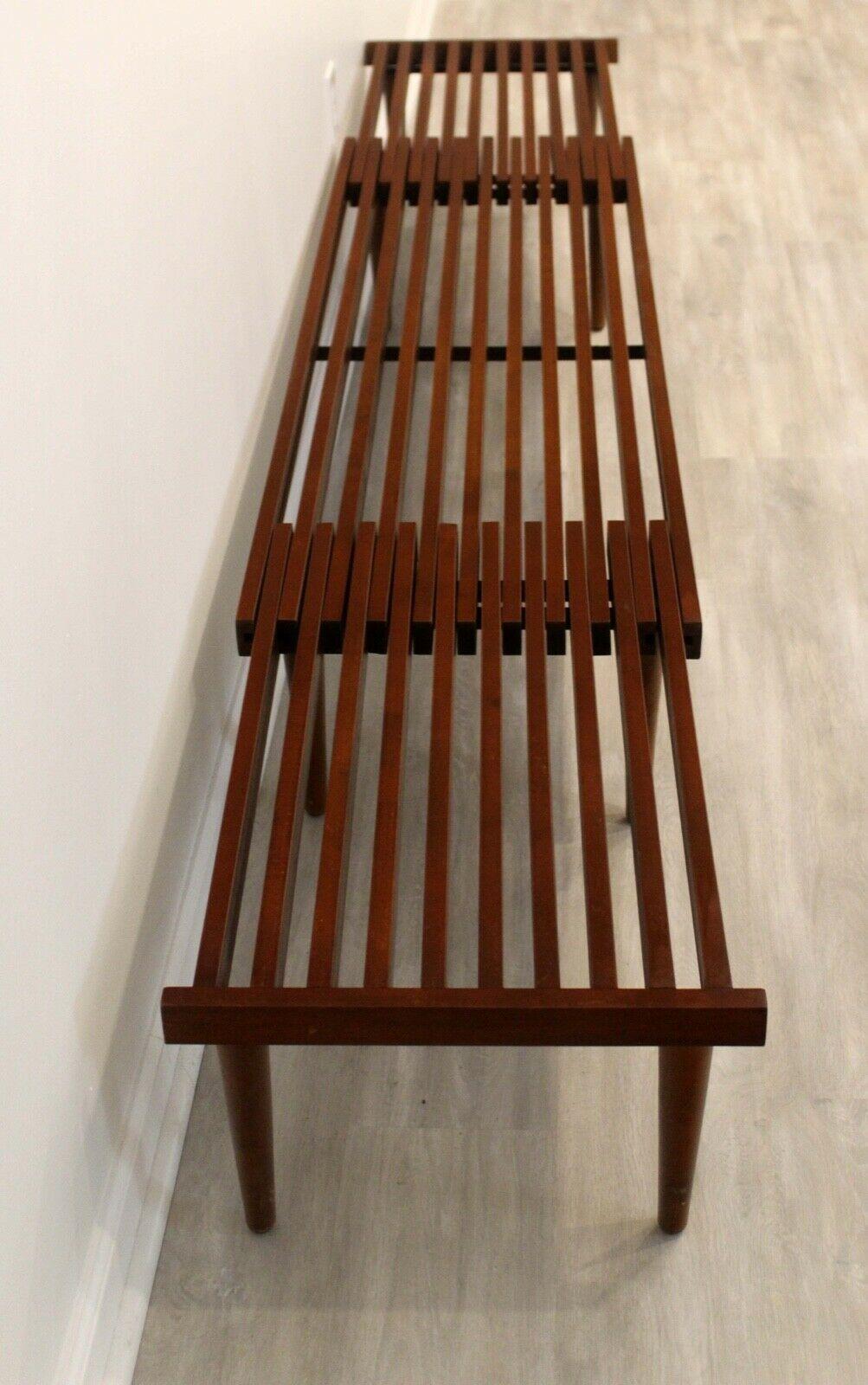 This sophisticated, slat walnut bench is an iconic addition to any Mid-Century Modern home and fully extends from 55.75