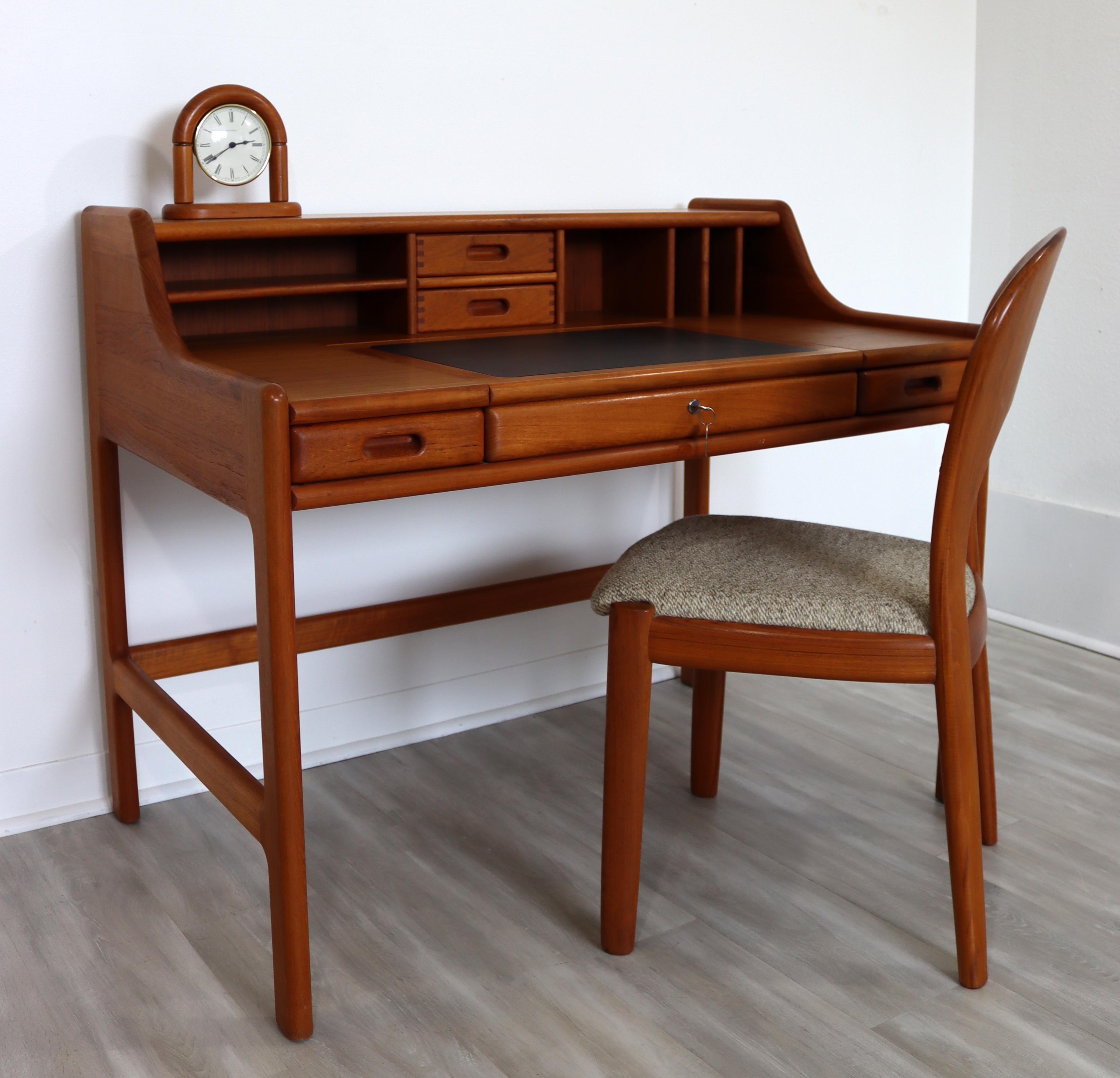 For your consideration is a fantastic solid teak desk, with matching chair and clock, by John Mortensen for Dyrlund Denmark, circa the 1970s. In excellent vintage condition. The dimensions of the desk are 43